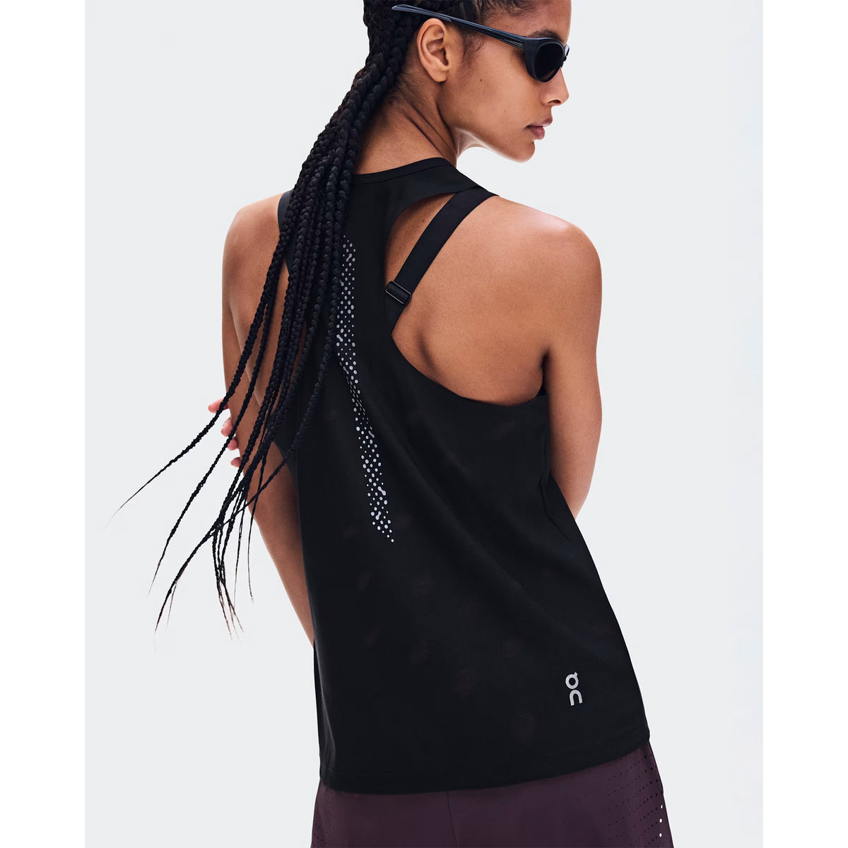 Women's On Zero Tank Breathe Black back view on female runner showing athletic racerback jacquard ventilation with reflective detailing and On DryTec moisture-wicking construction