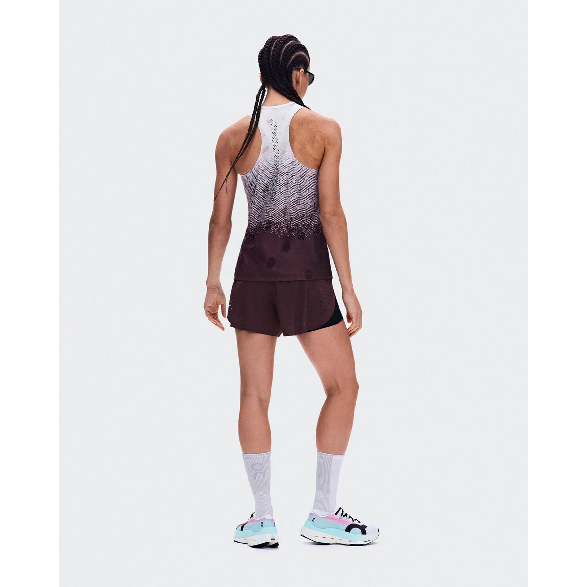 Women's On Zero Tank Breathe Foxglove White back full body view on female runner showing athletic racerback design with functional jacquard ventilation and signature reflective detailing for high-paced running
