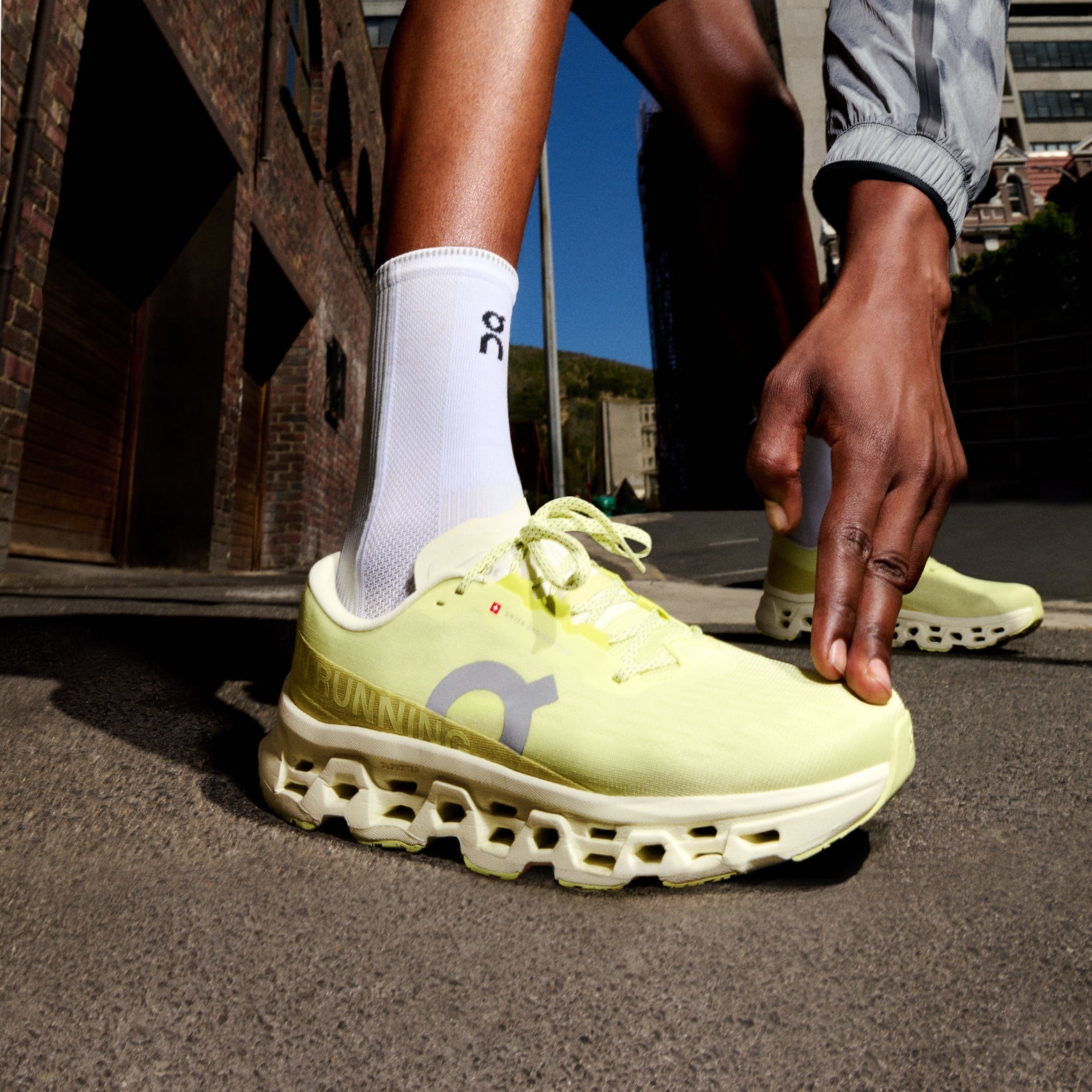 On Cloudmonster 3 max cushion running shoes yellow green colourway on runner