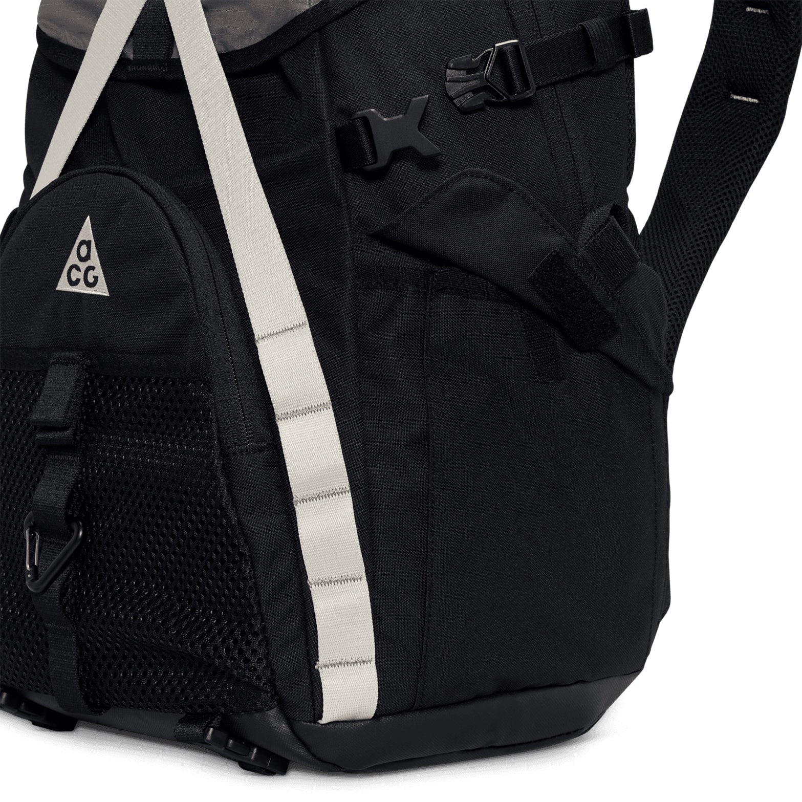 Close-up of the Nike ACG Daymax 25L Backpack in Black / College Grey, featuring white straps, a mesh front pocket, and the signature ACG triangle logo. The image highlights part of the main compartment, a buckle, and padded shoulder straps—showcasing this adventure-ready backpack’s practical design for all your outdoor needs.