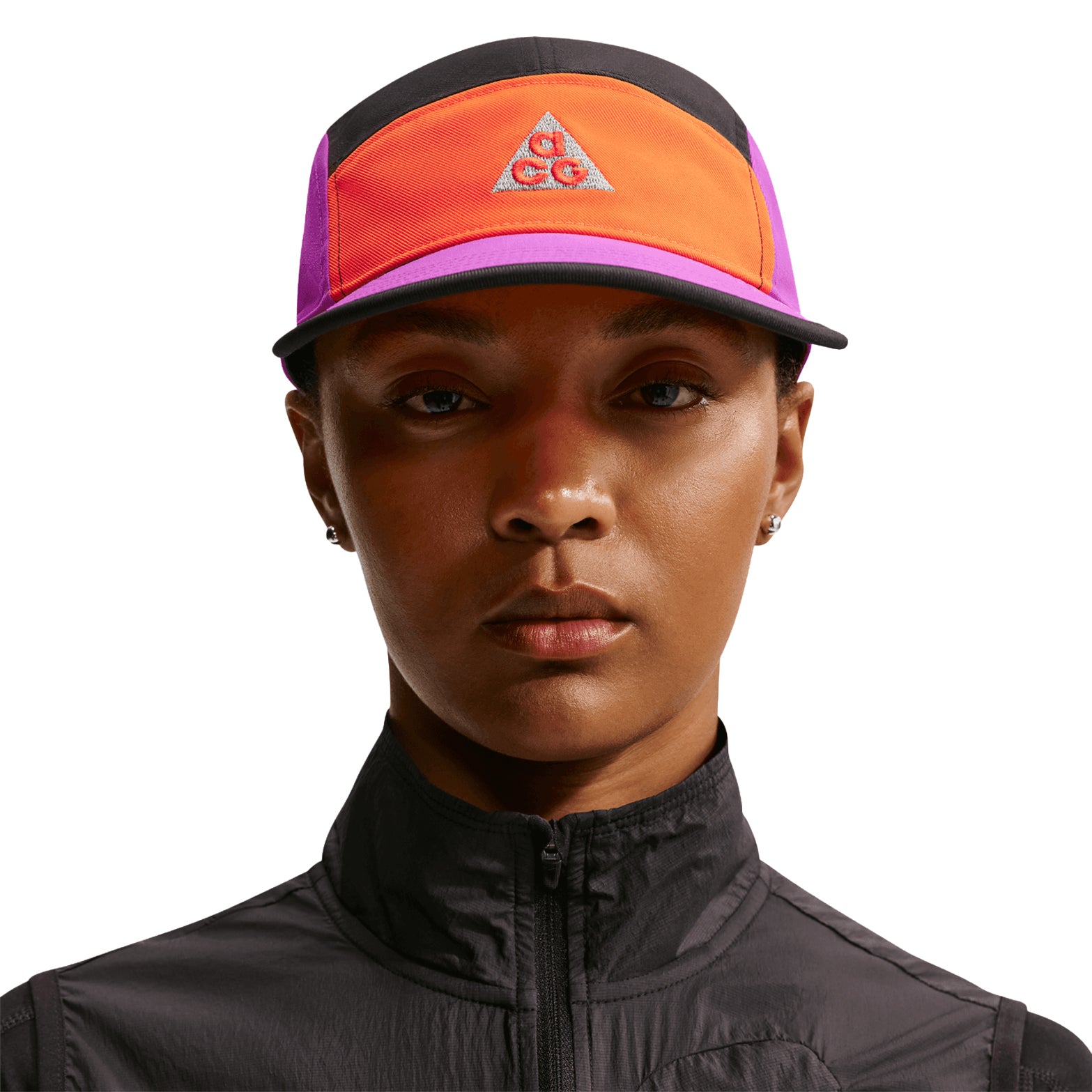 Nike ACG Fly Unstructured Cap Safety Orange Vivid Purple Black front view on model showing flat bill and embroidered Nike ACG logo