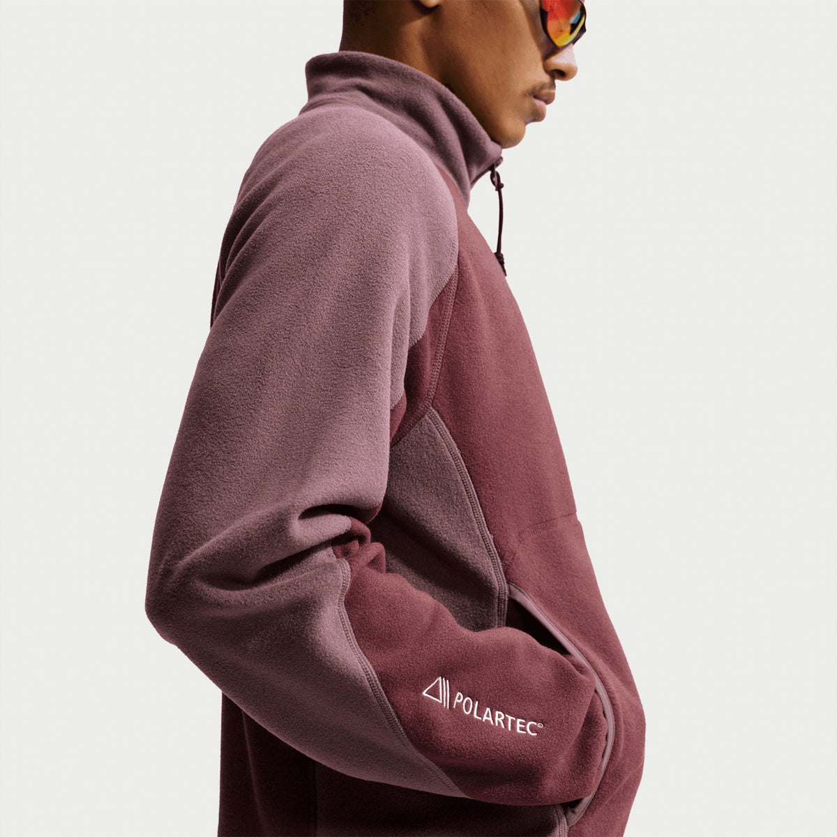Nike ACG Wolf Tree Full Zip Jacket Mystic Dates Tattoo Summit White side view on model showing classic fit with zippered pockets and Polartec fleece construction for mid-layer trail performance