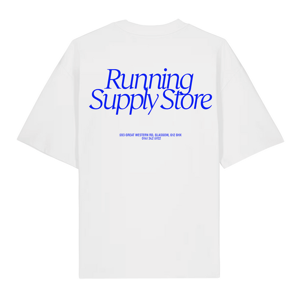 Achilles Heel’s Running Supply Store Tee White / Blue is a white oversized unisex t-shirt crafted from soft organic cotton for a comfortable, eco-friendly fit. The upper back features a large blue “Running Supply Store” print, with the address and phone number below in smaller blue text. All graphics are centered and printed using vegan inks.