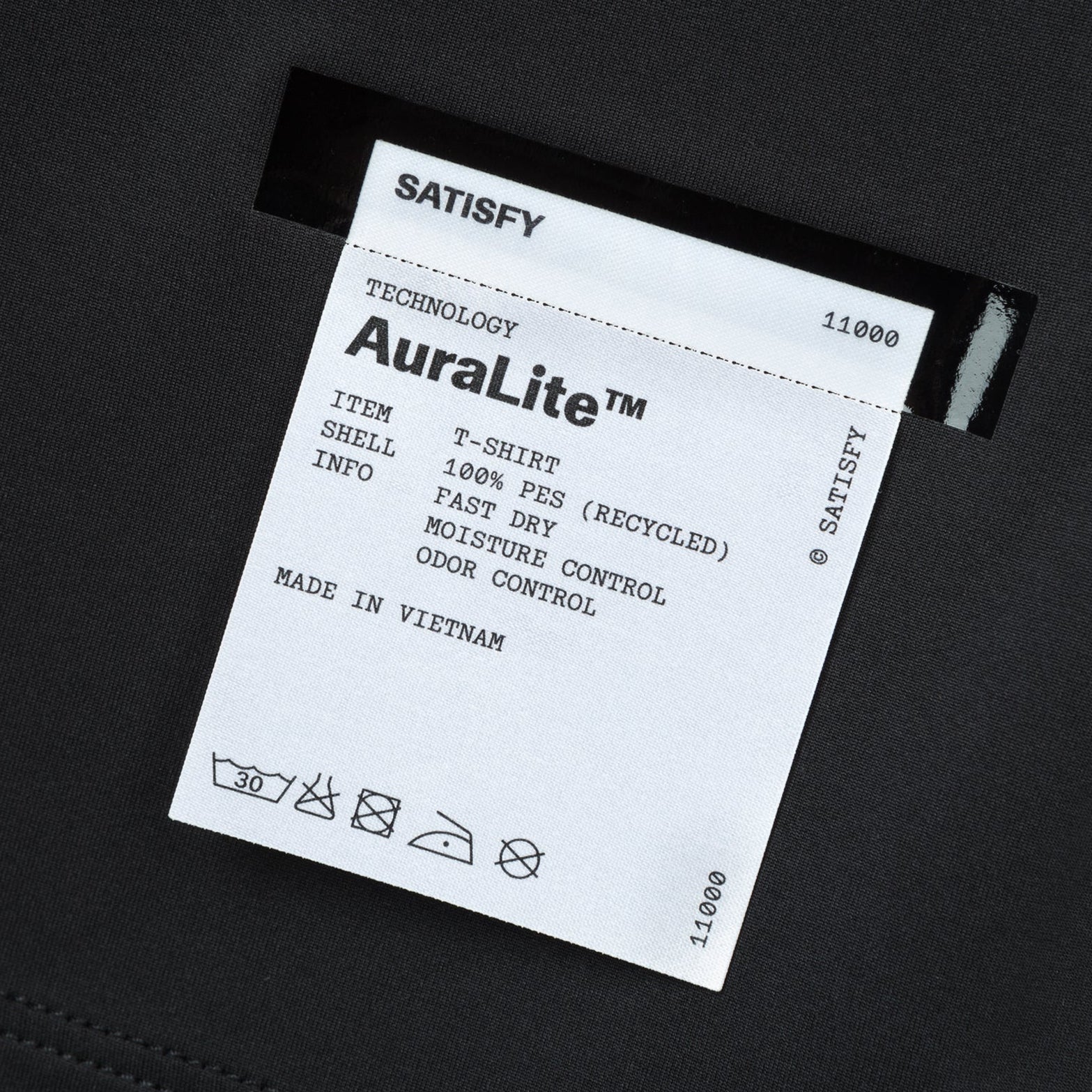 Satisfy AuraLite Tee Black close-up of fully detachable exterior care label with nothing inside interfering with skin contact