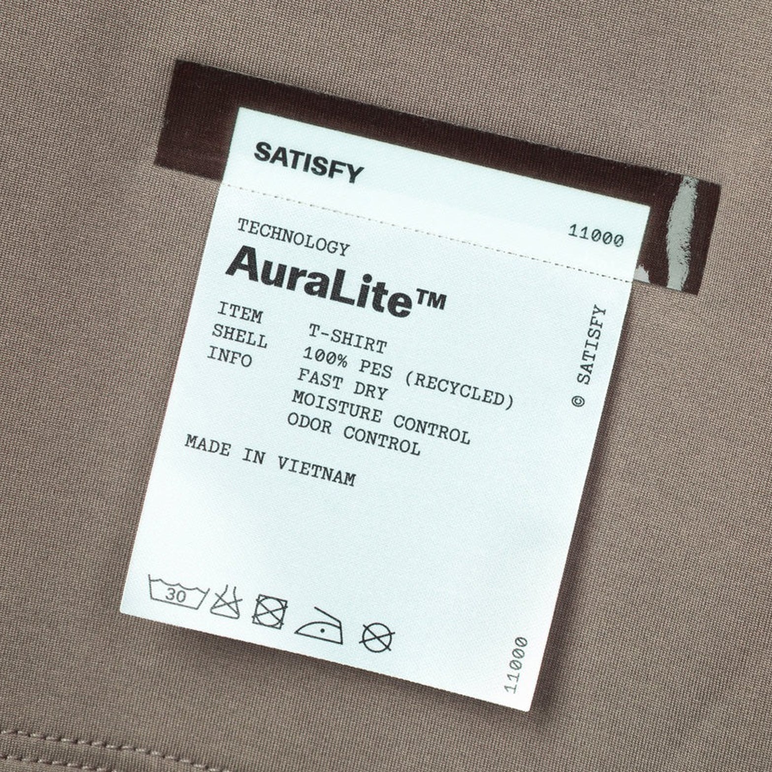 Satisfy AuraLite Tee Pigment Falcon close-up of fully detachable exterior care label with nothing inside interfering with skin contact