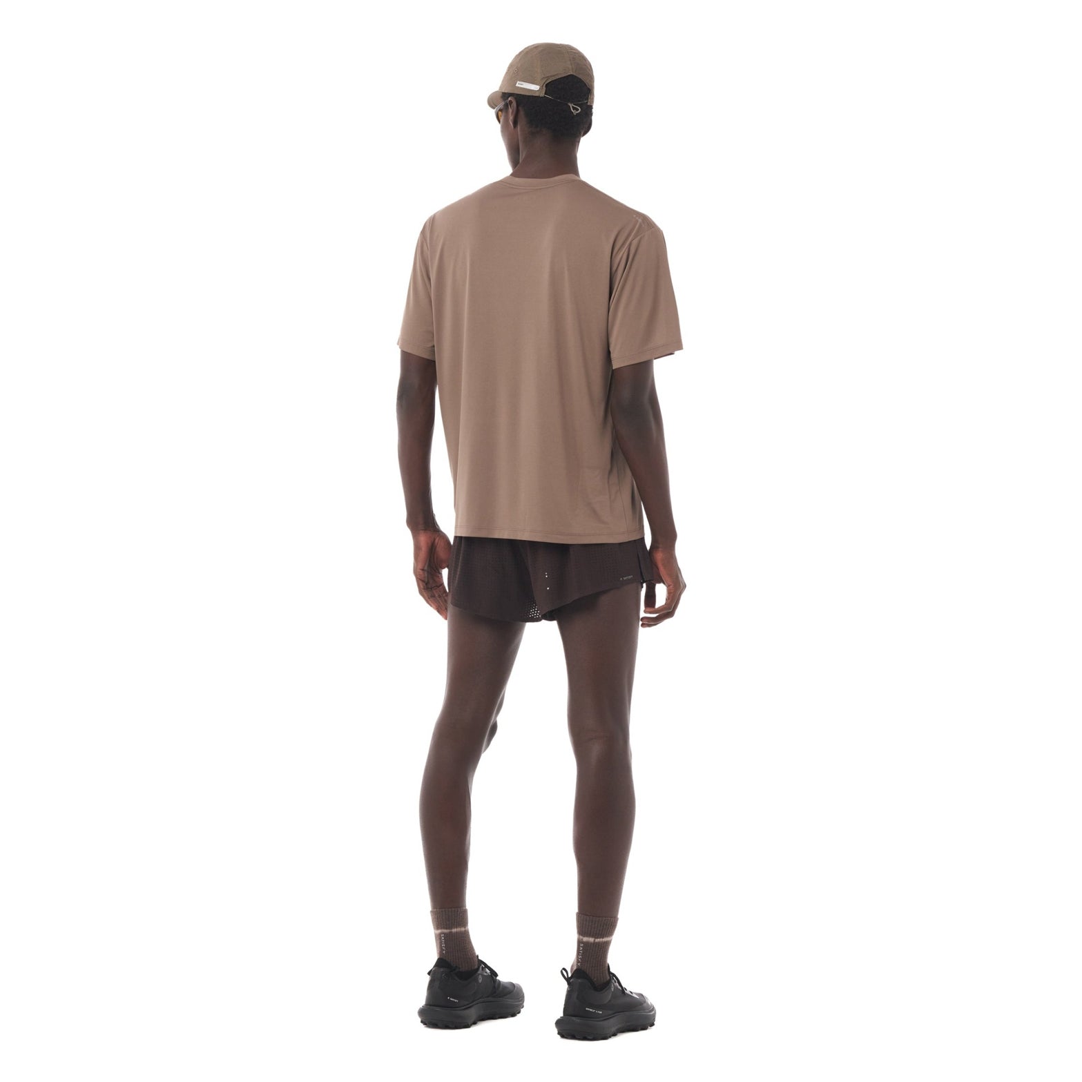 Satisfy AuraLite Tee Pigment Falcon full body back view on male runner showing moisture control fabric with stealth-reflective logo for low-light visibility