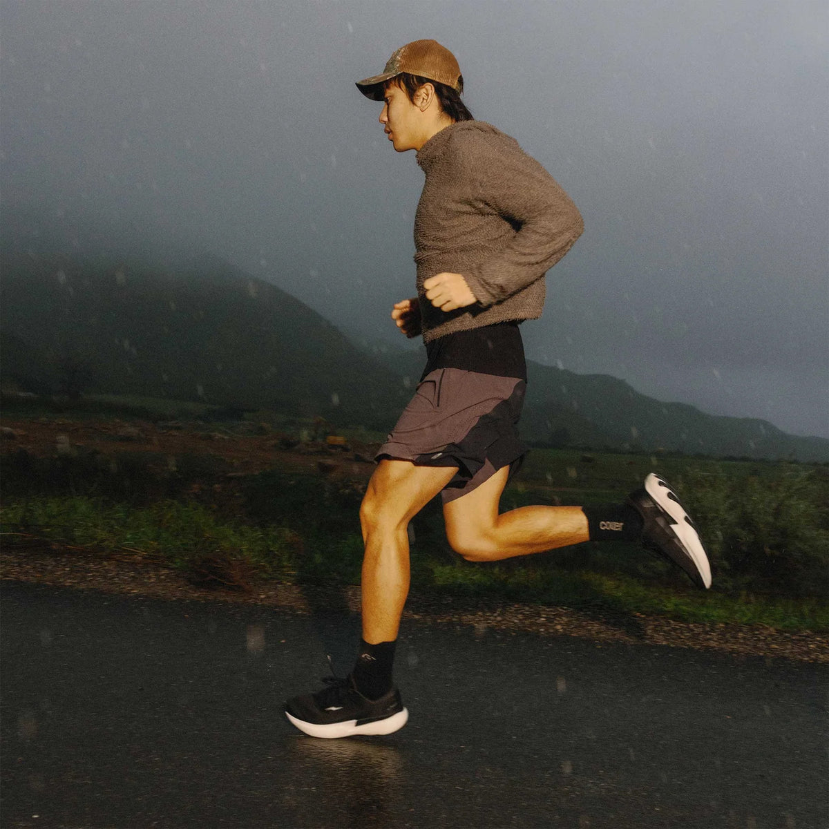 Hylo AXIS Running Shoes Black Undyed worn by runner in motion showing 38mm stack bio-based Hyperbolt foam, smooth heel-to-toe transition and sustainable maximum cushioning performance