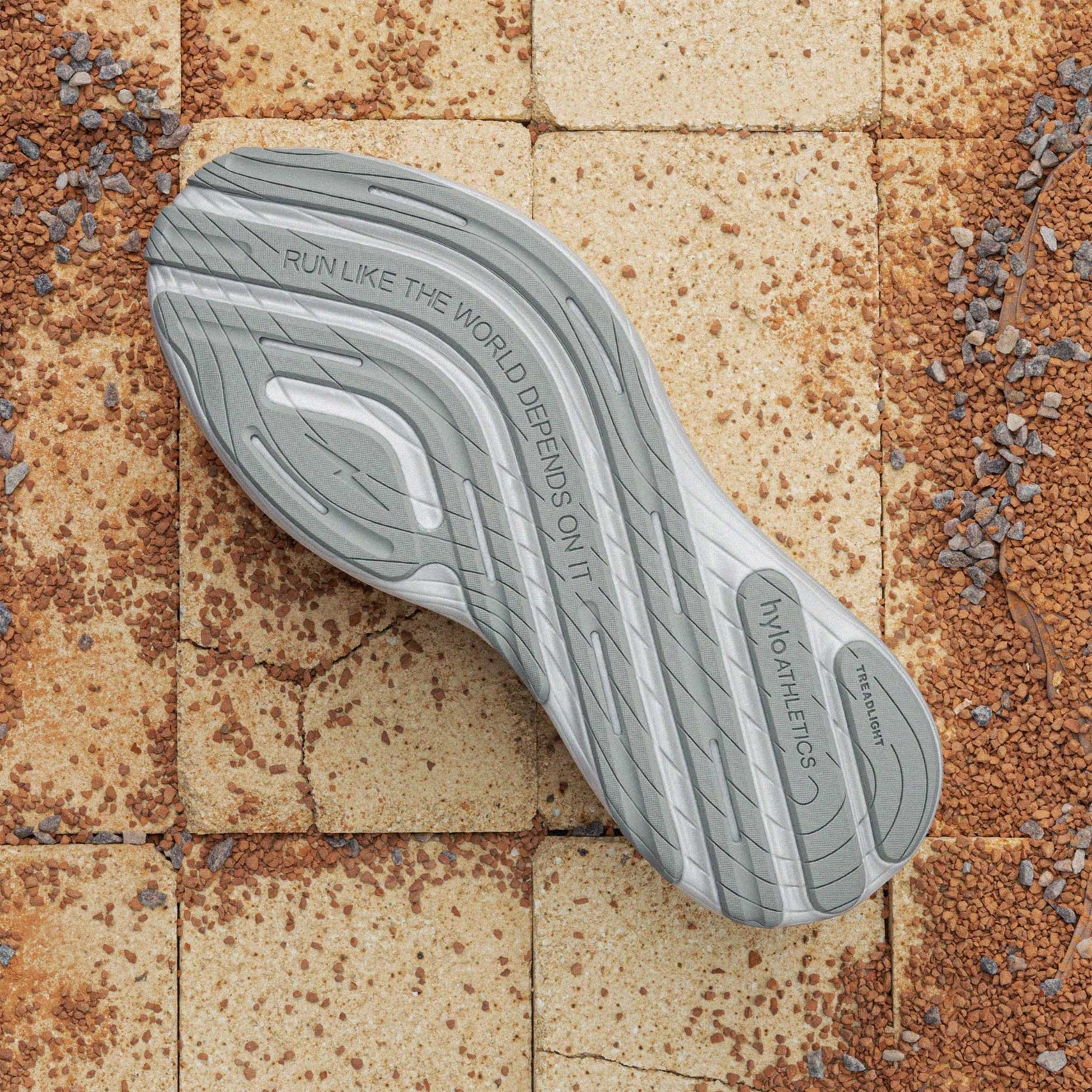 Hylo AXIS Running Shoes Grey sole view displaying 60% natural rubber TreadLight outsole with redesigned tread pattern for water displacement and traction