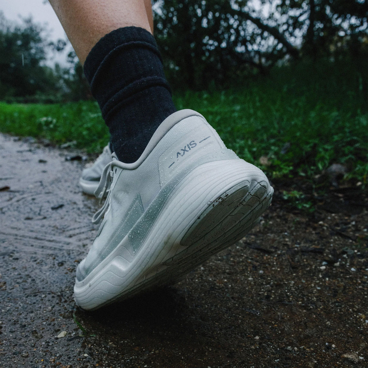 Hylo AXIS Running Shoes Grey worn by runner in motion showing 38mm stack bio-based Hyperbolt foam, smooth heel-to-toe transition and sustainable maximum cushioning performance