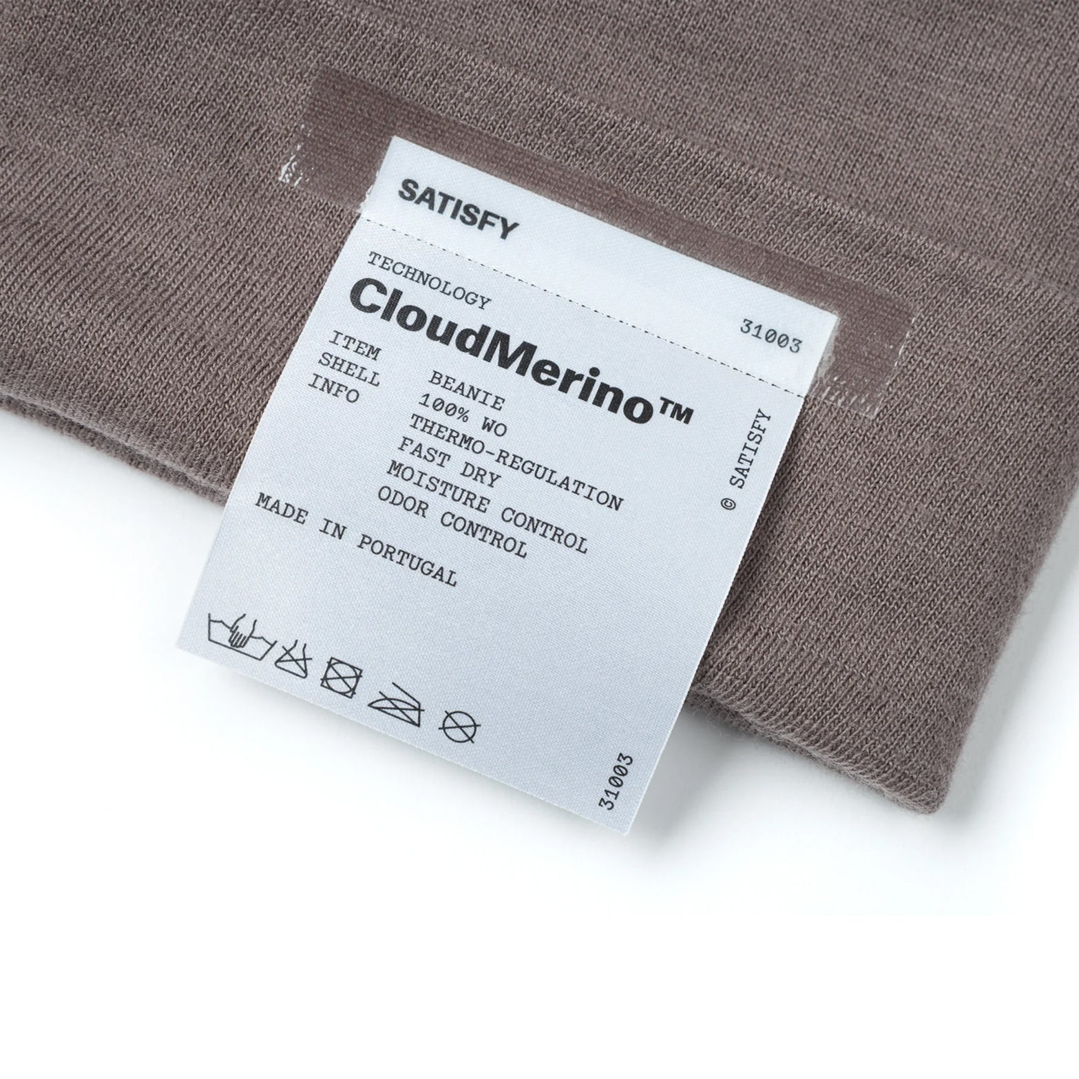 Satisfy CloudMerino™ Beanie in Shark — closeup showing fully detachable exterior care label on shark grey CloudMerino™ Optimo wool jersey construction