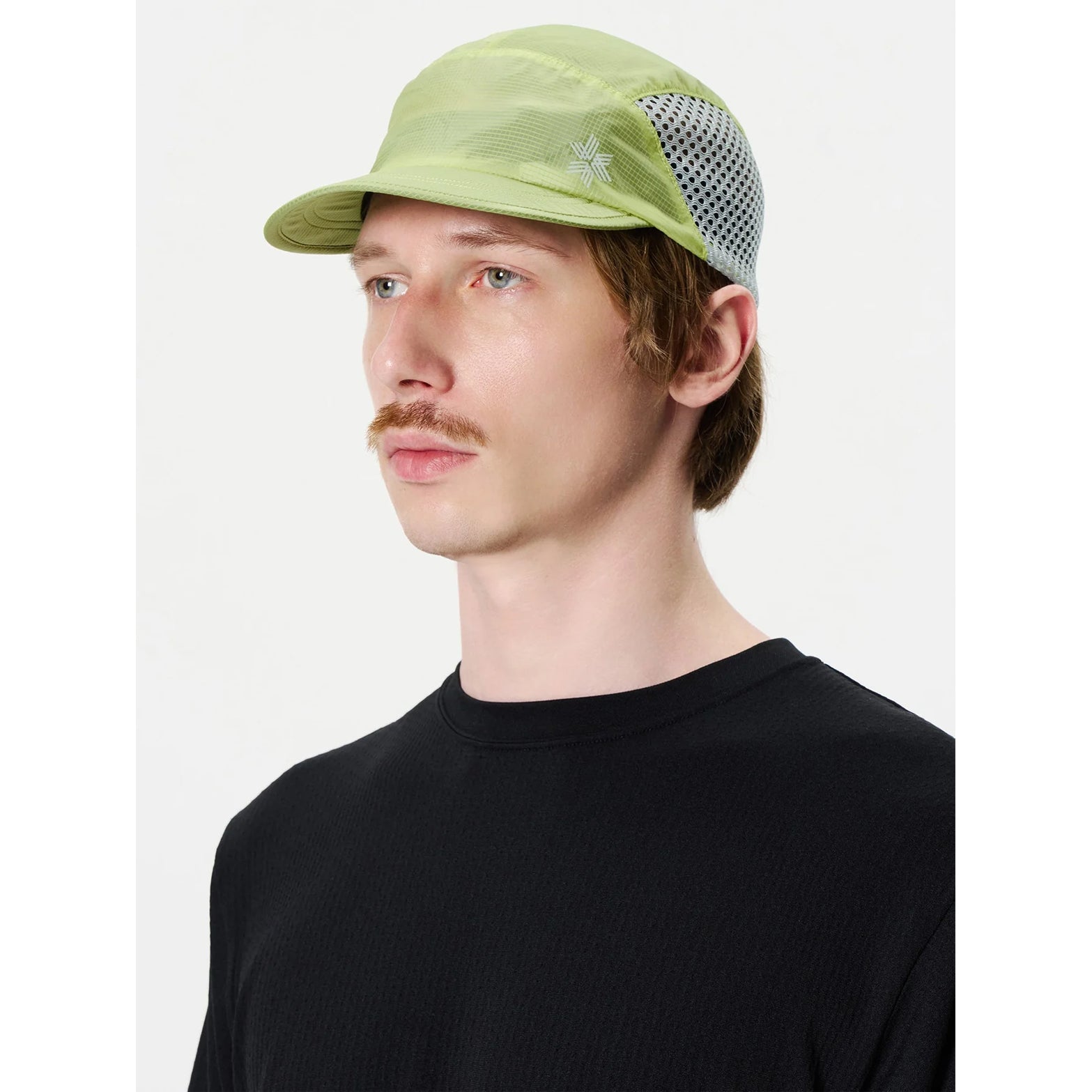 Goldwin Compact Run Mesh Cap Usuyanagi side view on male model showing breathable mesh side inserts and upward-foldable visor for trail running