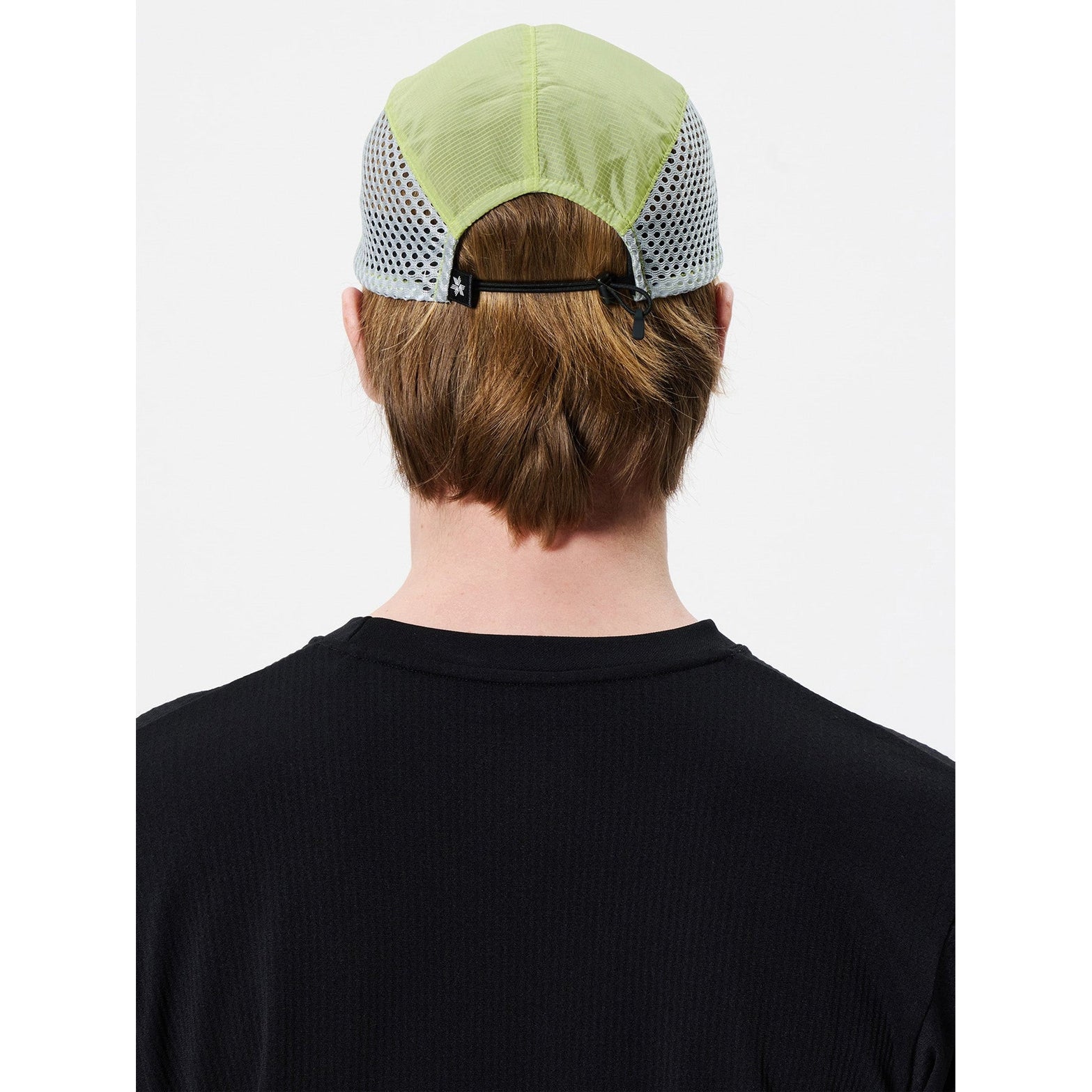 Goldwin Compact Run Mesh Cap Usuyanagi back view on male model showing drawstring size adjustment and moisture-wicking sweatband construction