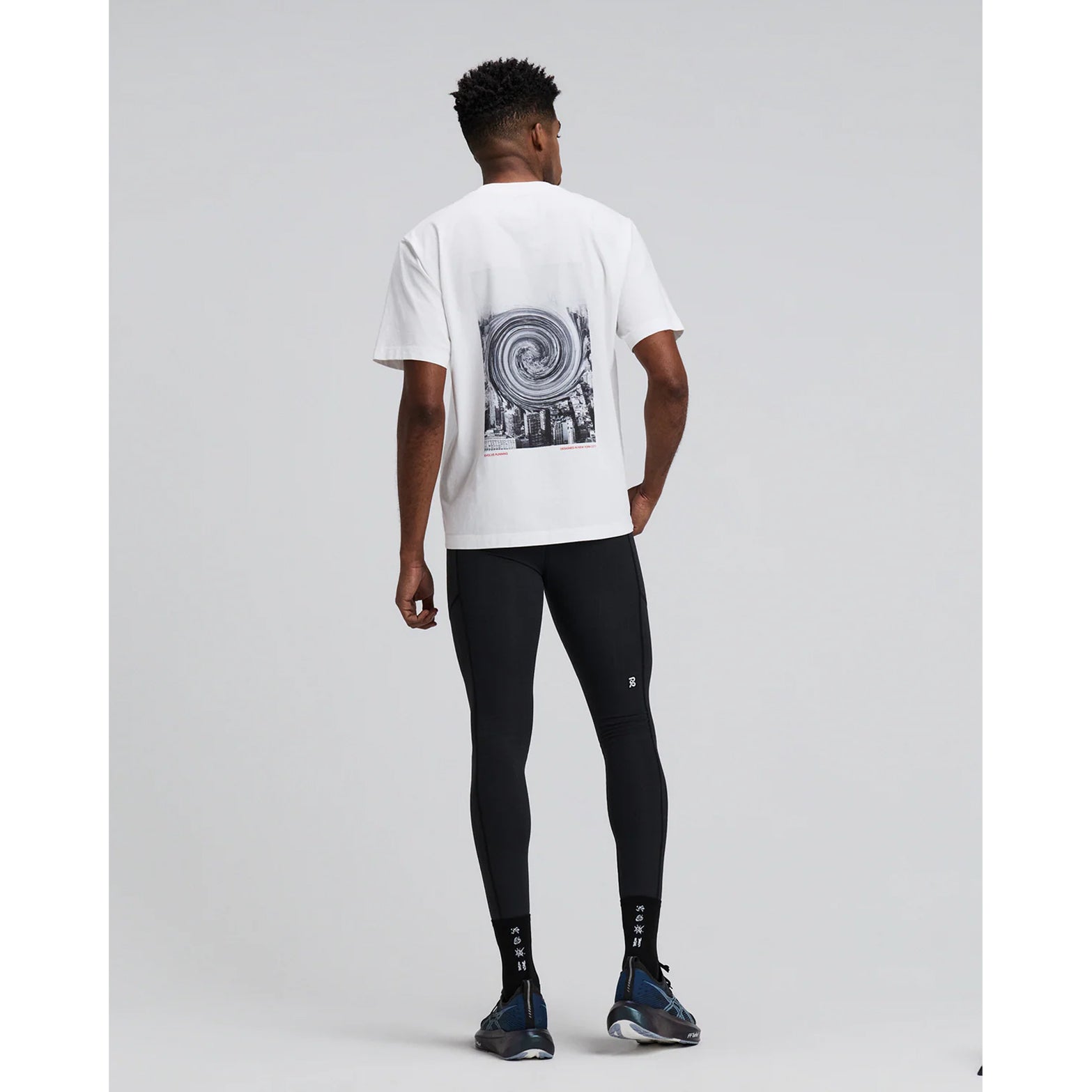 Bandit Cotton Tee Twisted City unisex in White — full body back view worn on model showing relaxed fit silhouette and white 100% combed cotton construction