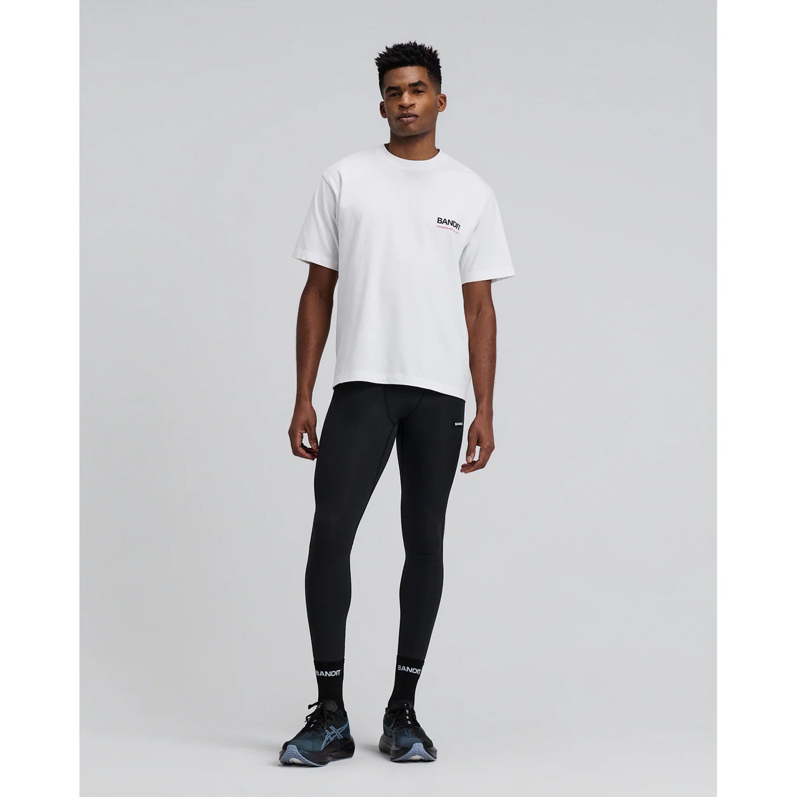 Bandit Cotton Tee Twisted City unisex in White — full body front view worn on model showing relaxed fit, Twisted City graphic print and white combed cotton fabric drape