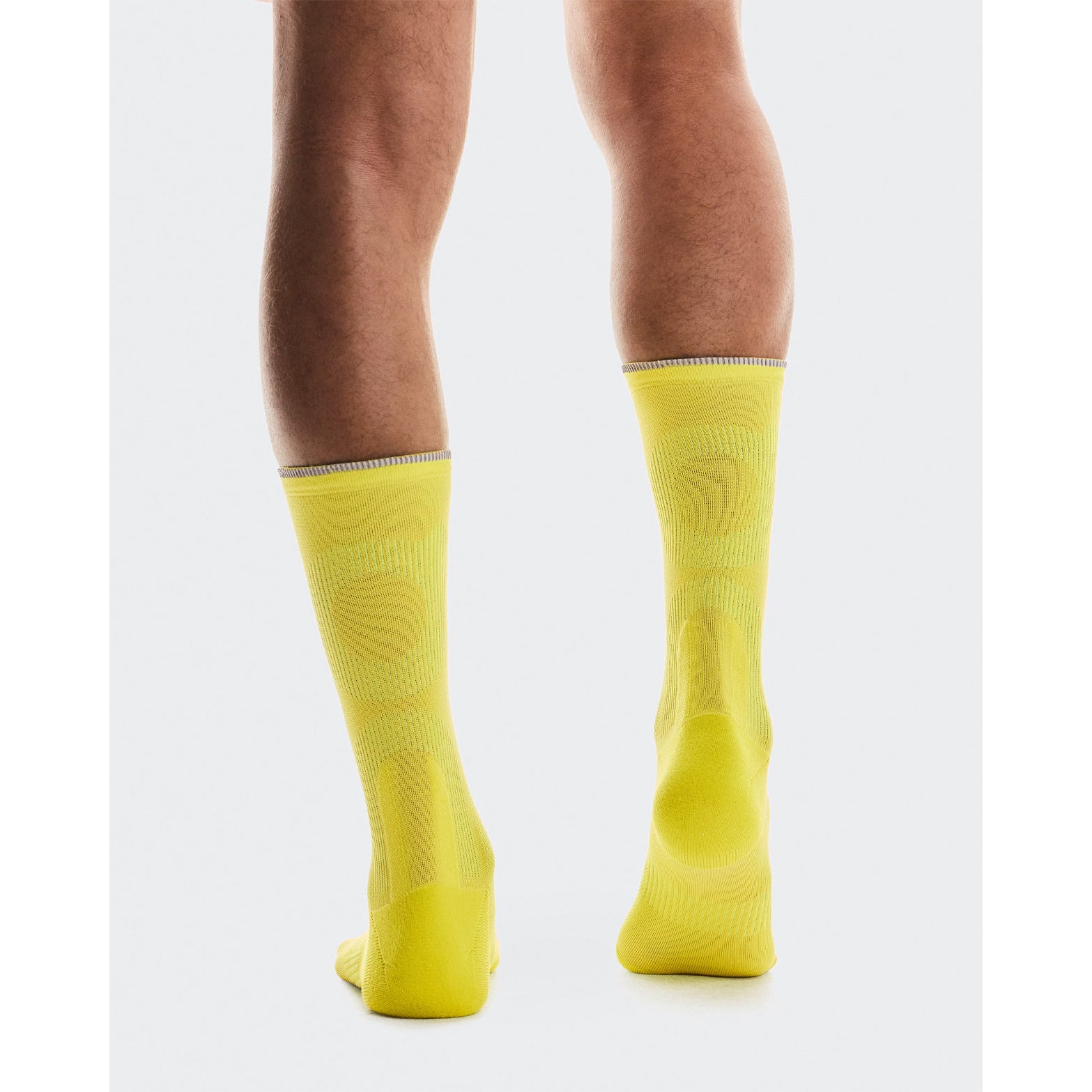 On Elite Run Sock High Lime back view showing reflective yarn on cuff for visibility with ventilation panels to help reduce blistering during distance running
