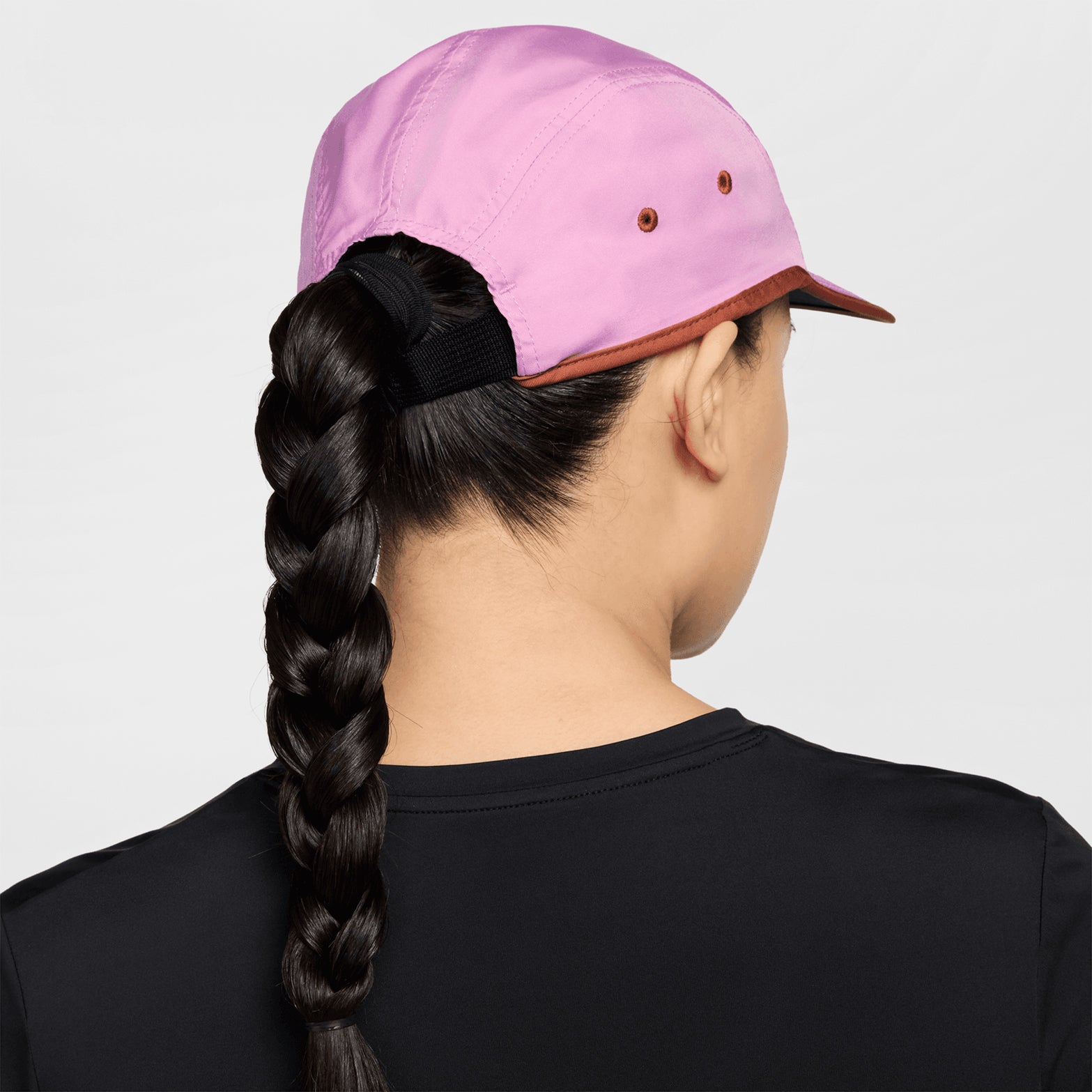 Nike Fly Unstructured Swoosh Cap Light Magenta Dusty Peach Anthracite Orange Frost back view showing webbed strap closure with adjustable sizing for secure comfortable fit