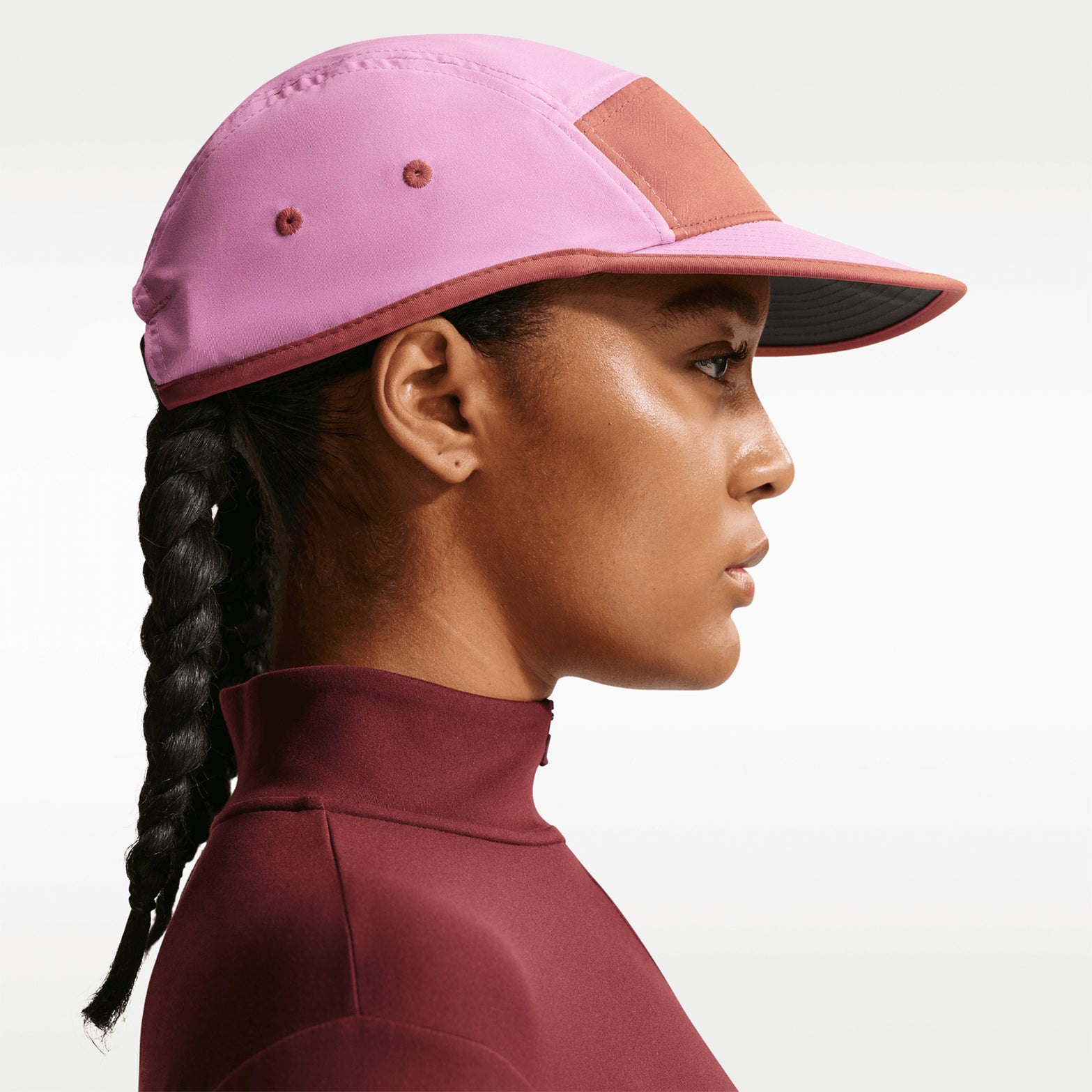 Nike Fly Unstructured Swoosh Cap Light Magenta Dusty Peach Anthracite Orange Frost side view showing unstructured crown with four-way stretch twill fabric and Dri-FIT moisture-wicking construction