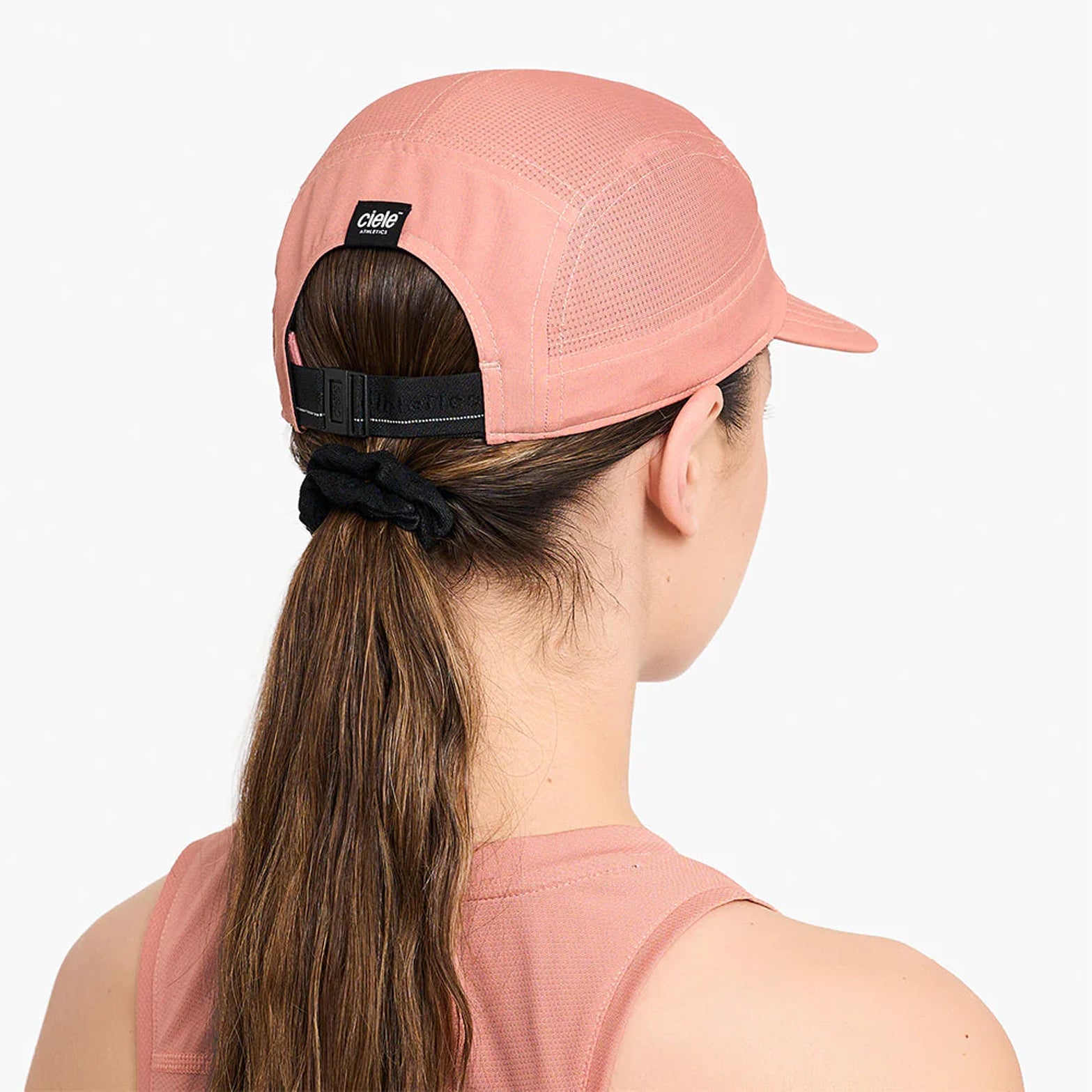 Ciele GOCap Comp Century Rose Dawn back view on runner showing reflective detailing for night run visibility with fast-drying mesh construction
