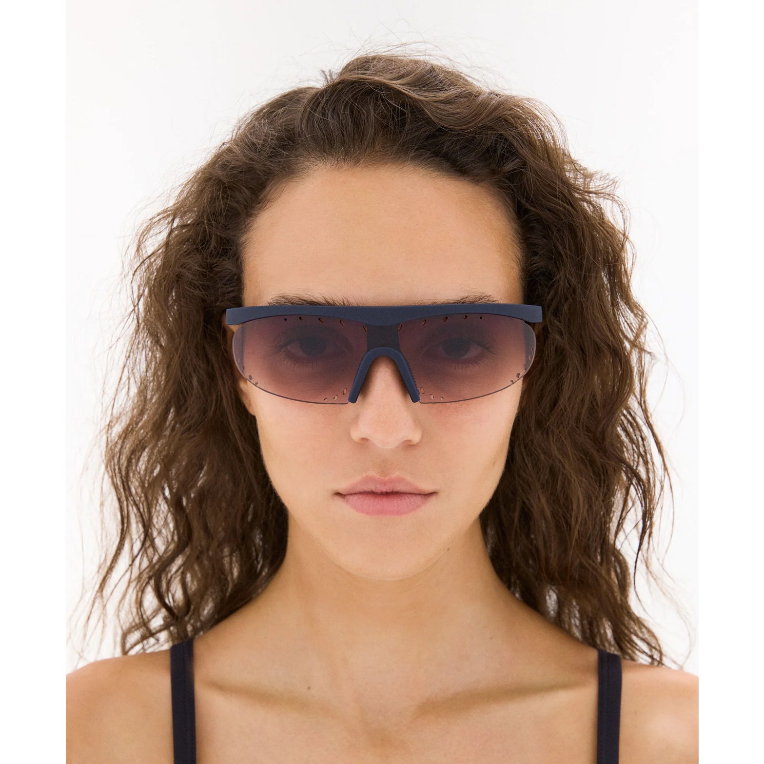 District Vision x PAF Koharu Eclipse in Deep Sea D+ Brown Gradient — worn on female model showing six-base blade-style frame fit, deep sea colourway and D+ Brown Gradient lens in natural light