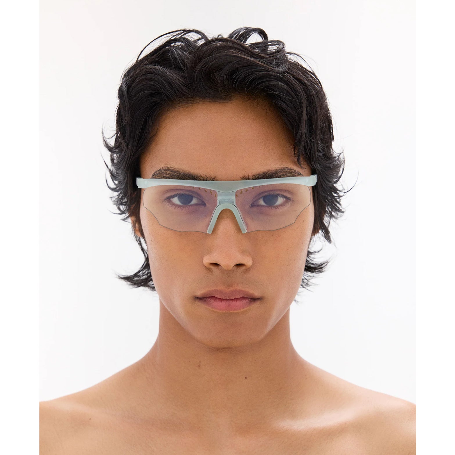 District Vision x PAF Koharu Eclipse in Lichen D+ Sports Gray — worn on male model showing six-base blade-style frame fit, lichen colourway and D+ Sports Grey lens in natural light