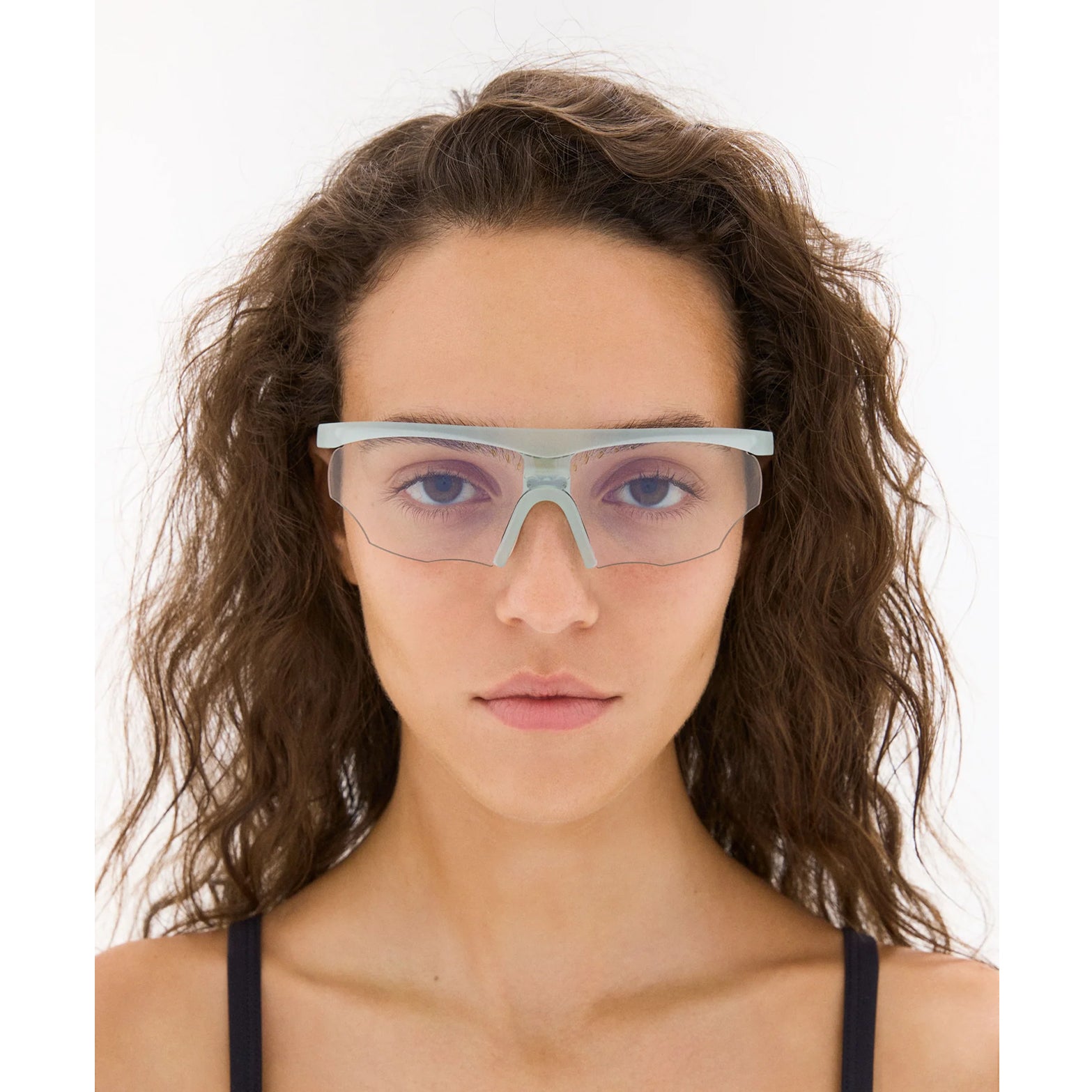 District Vision x PAF Koharu Eclipse in Lichen D+ Sports Gray — worn on female model showing six-base blade-style frame fit, lichen colourway and D+ Sports Grey lens in natural light