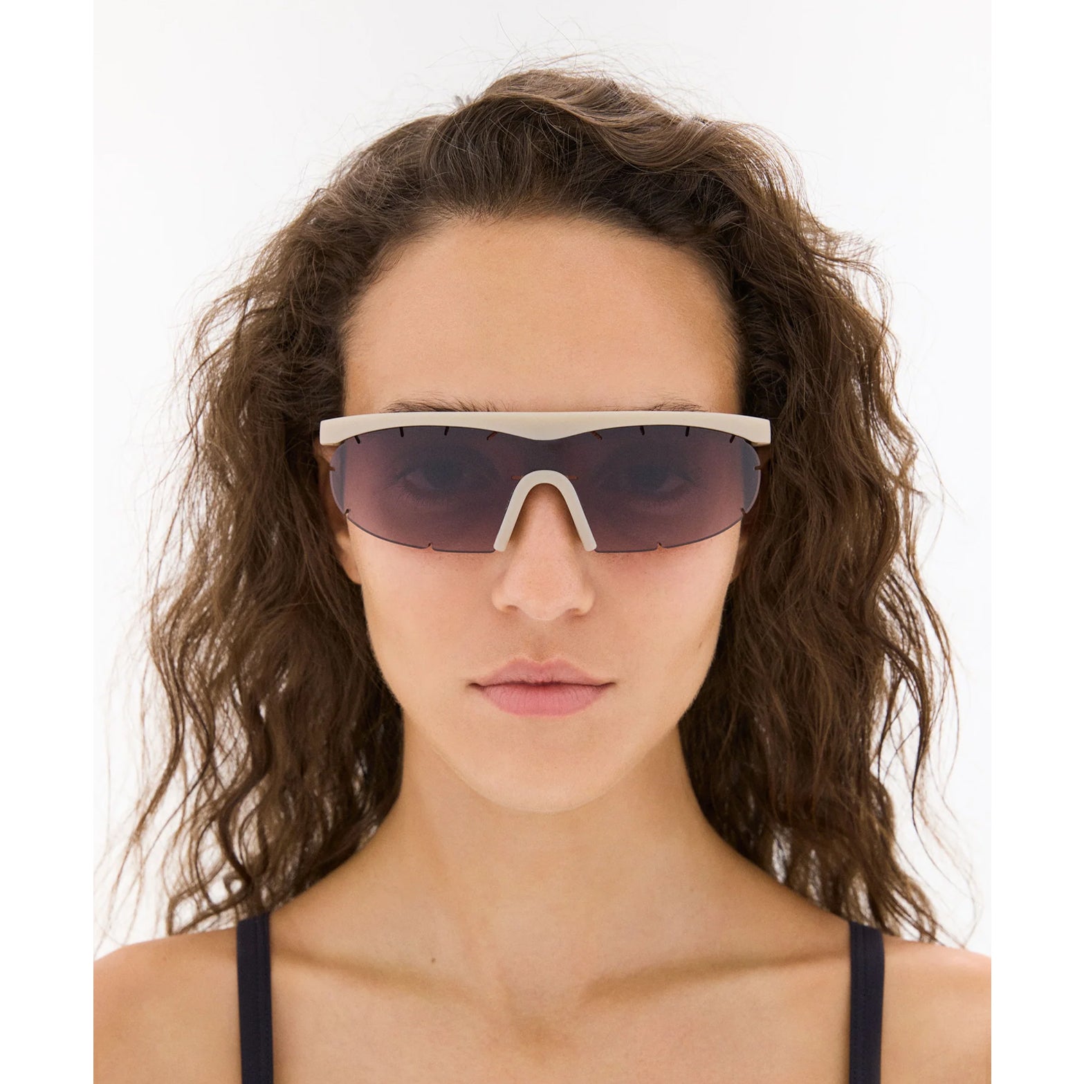 District Vision x PAF Koharu Eclipse in Sand D+ Black Rose Gradient — worn on female model showing six-base blade-style frame fit, sand colourway and D+ Black Rose Gradient lens in natural light