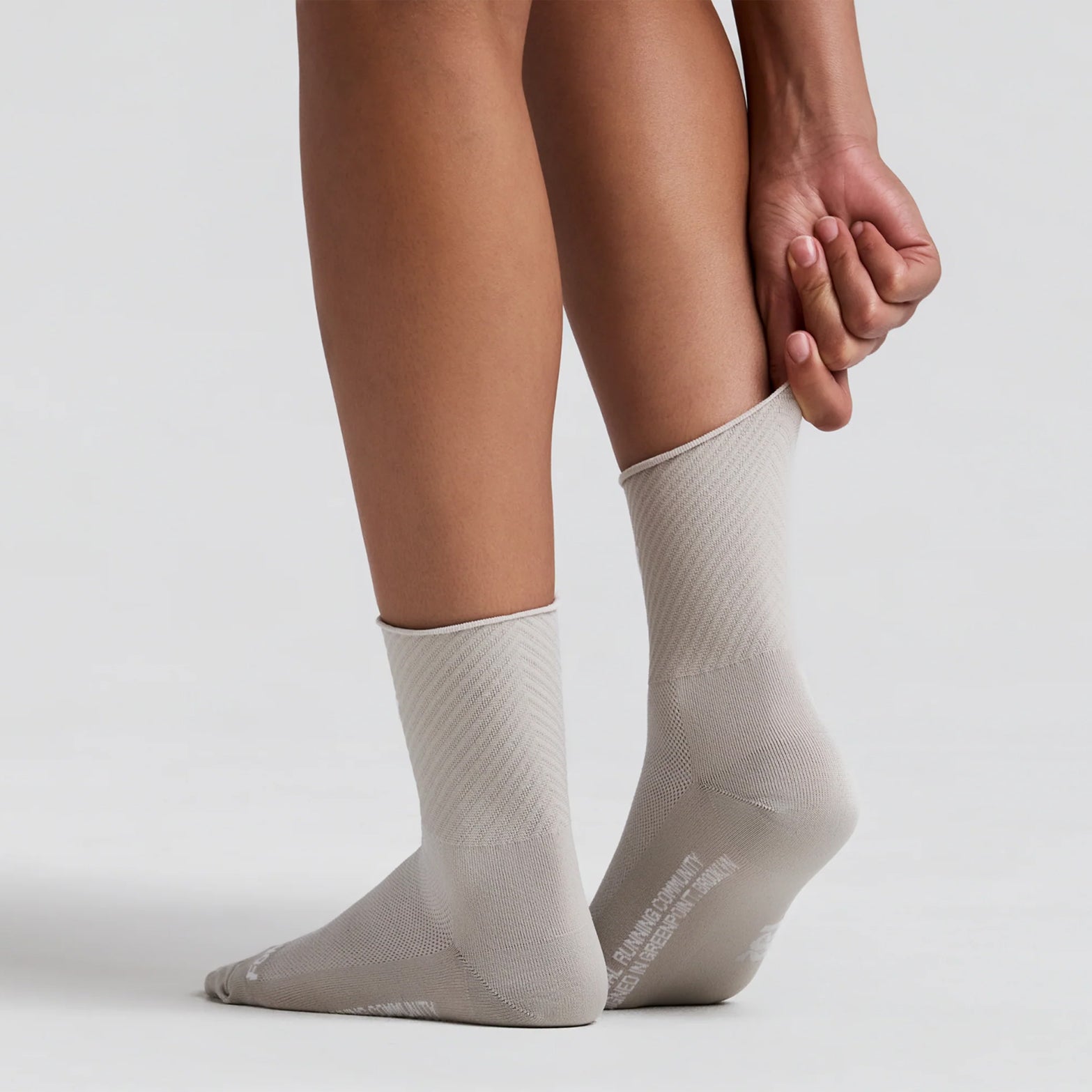 Bandit Lite Run 2 Pack Stripe Jacquard Socks Plaster back view on runner showing quarter-length stripe jacquard construction with spandex compression fit and ribbed knit Bandit branding at ankle for secure featherweight running