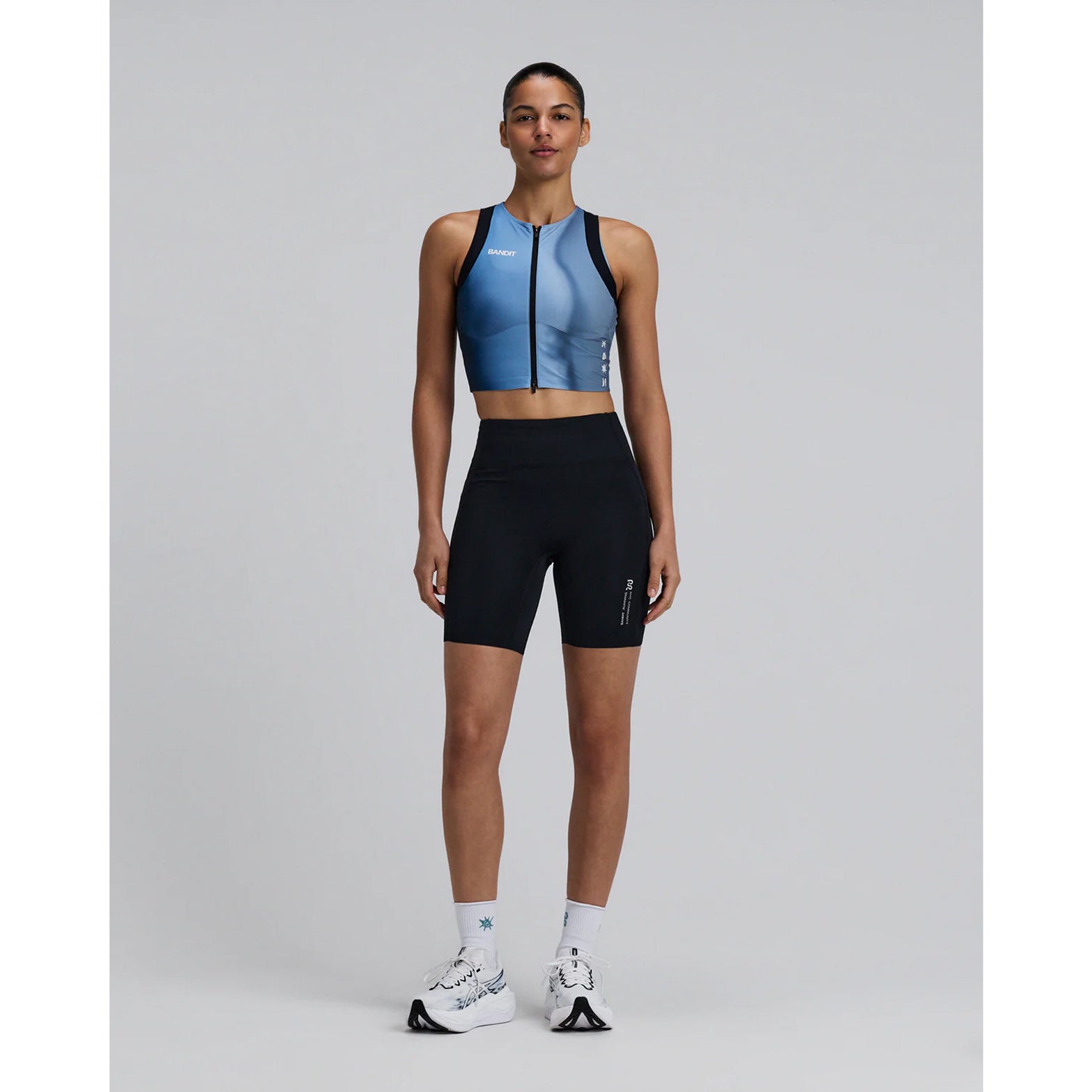 Bandit Lite Run™ Ribbed Quarter Socks in White / Tranquil Blue — full body front view worn on model showing quarter-length cut and white and tranquil blue ribbed detail with running kit