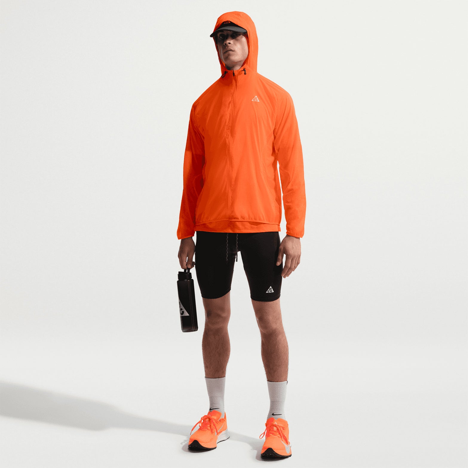 Men's Nike ACG Dri-FIT ADV Half Tights Black Summit White full body front view on male runner showing 1/2-length cut with Dri-FIT brief liner and reflective logos