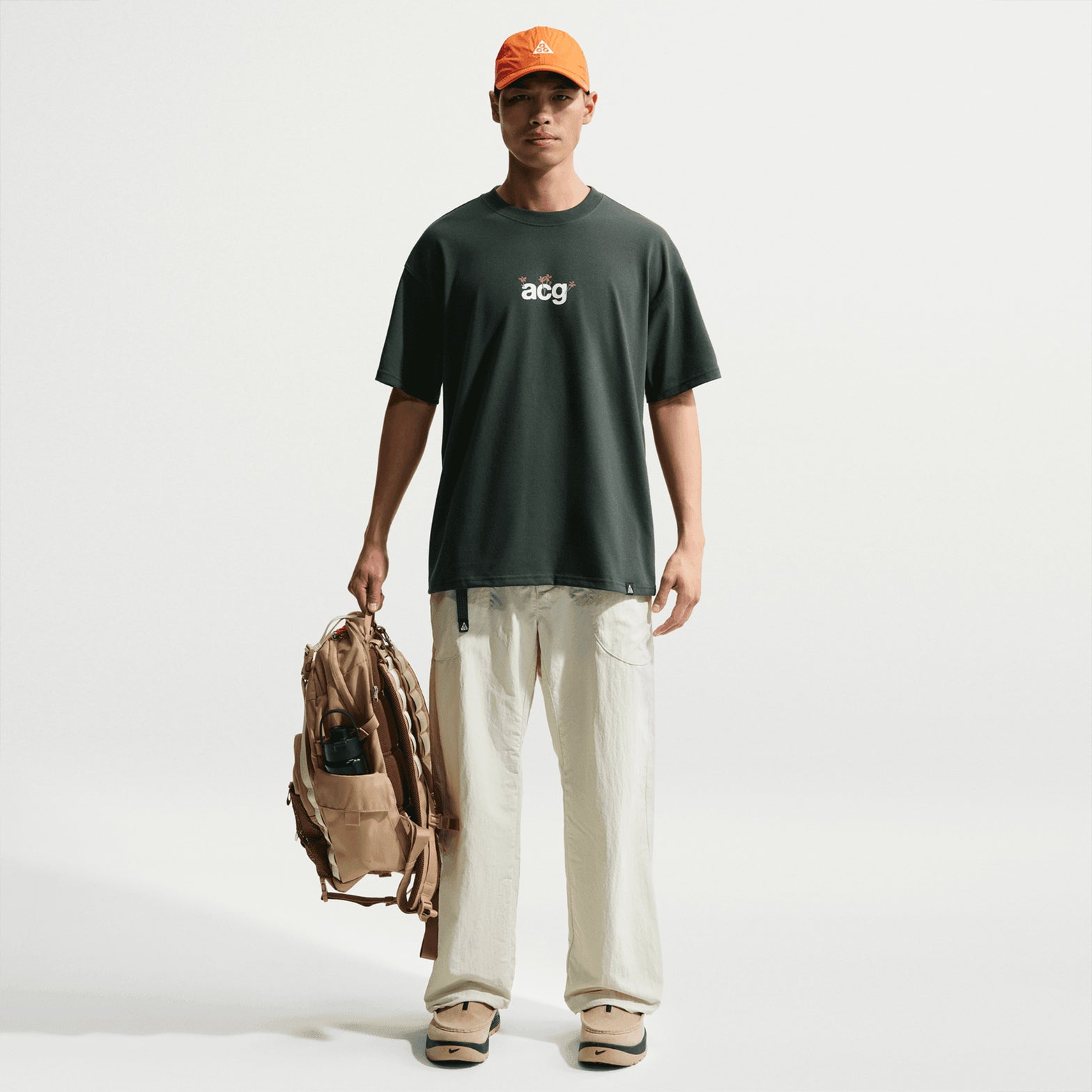 Nike ACG men's Dri-FIT tee in Black Spruce — full body front view worn on model showing black spruce relaxed fit, smooth fabric and comfortable all-conditions gear design