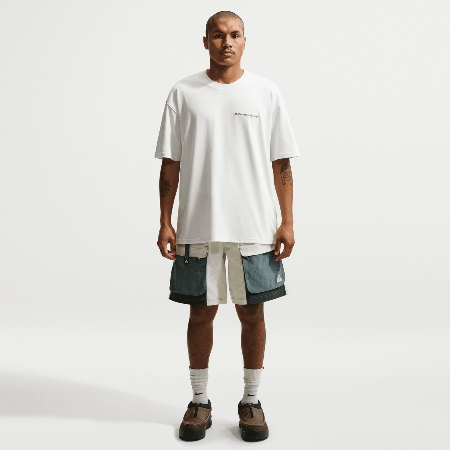 Men's Nike ACG Dri-FIT Tee Summit White full body view on male runner showing breathable construction with Dri-FIT technology for trail running and mountain activities