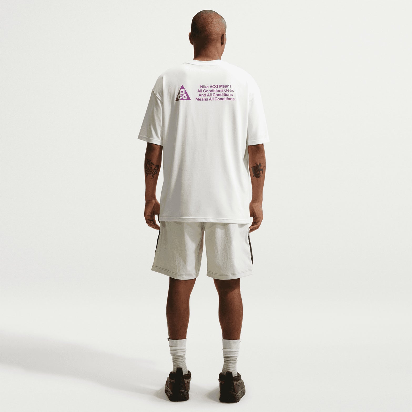 Men's Nike ACG Dri-FIT Tee Summit White full body back view on male runner showing breathable Dri-FIT construction for all-conditions trail running and mountain wear