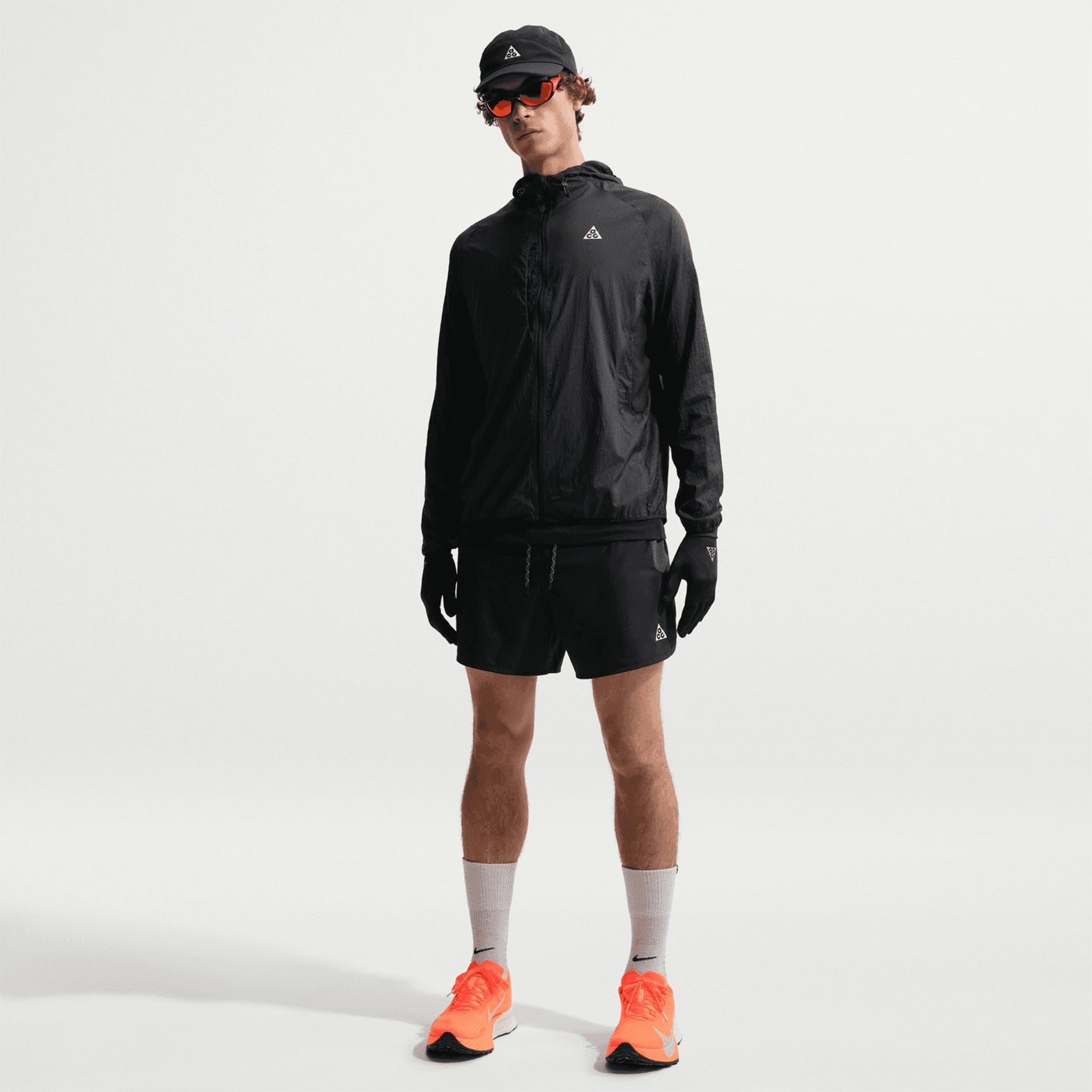 Men's Nike ACG Second Sunrise Dri-FIT 5 Inch Running Shorts Black Anthracite Summit White full body view on male trail runner showing 5-inch inseam with high-positioned pockets and trekking pole loops for long-distance journeys