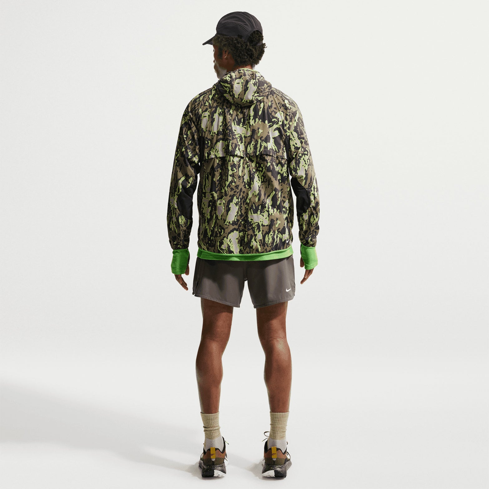 Men's Nike ACG Second Sunrise Dri-FIT 5 Inch Running Shorts Ironstone Cave Stone Summit White full body view on male trail runner showing 5-inch inseam with high-positioned pockets and trekking pole loops for long-distance journeys