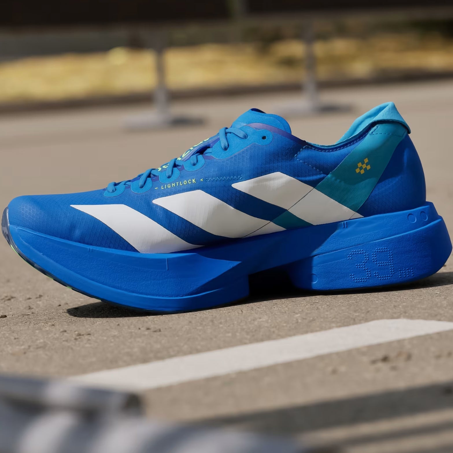 Men's adidas Adizero Adios Pro 4 Running Shoes Blue Cloud White Lime Burst inner side view showing LIGHTSTRIKE PRO cushioning with carbon ENERGYRODS 2.0 technology for race day performance