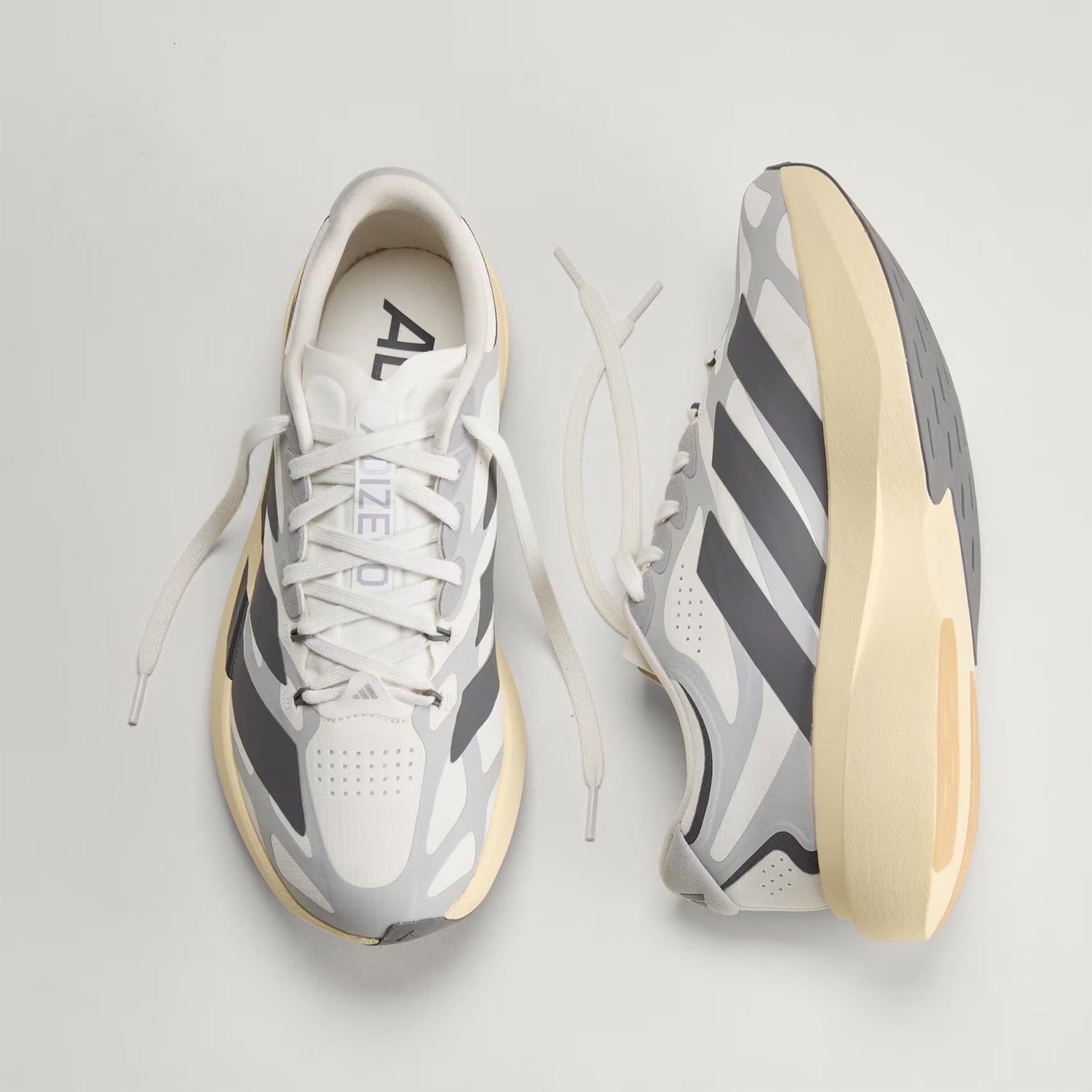 Men's adidas Adizero EVO SL EXO Running Shoes Core White Utility Black Grey Two showing top view of EXOSKELETON upper fit system alongside inner side view displaying LIGHTSTRIKE PRO super-light cushioning with heel-to-toe precision support for dynamic running and lifestyle wear