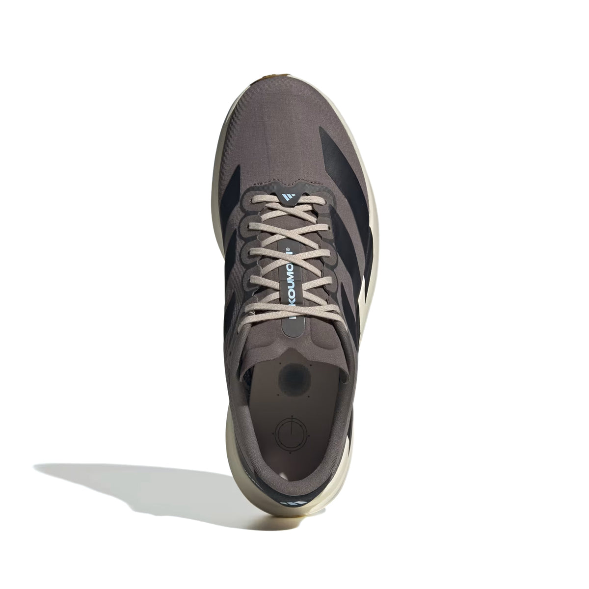 A top view of the Adidas Men’s Adizero EVO SL Woven H.Koumori Running Shoe in Charcoal, Night Grey, and Clear Sky, featuring white laces, black side stripes, and a beige sole with LIGHTSTRIKE PRO technology, set against a white background with a shadow on the left.
