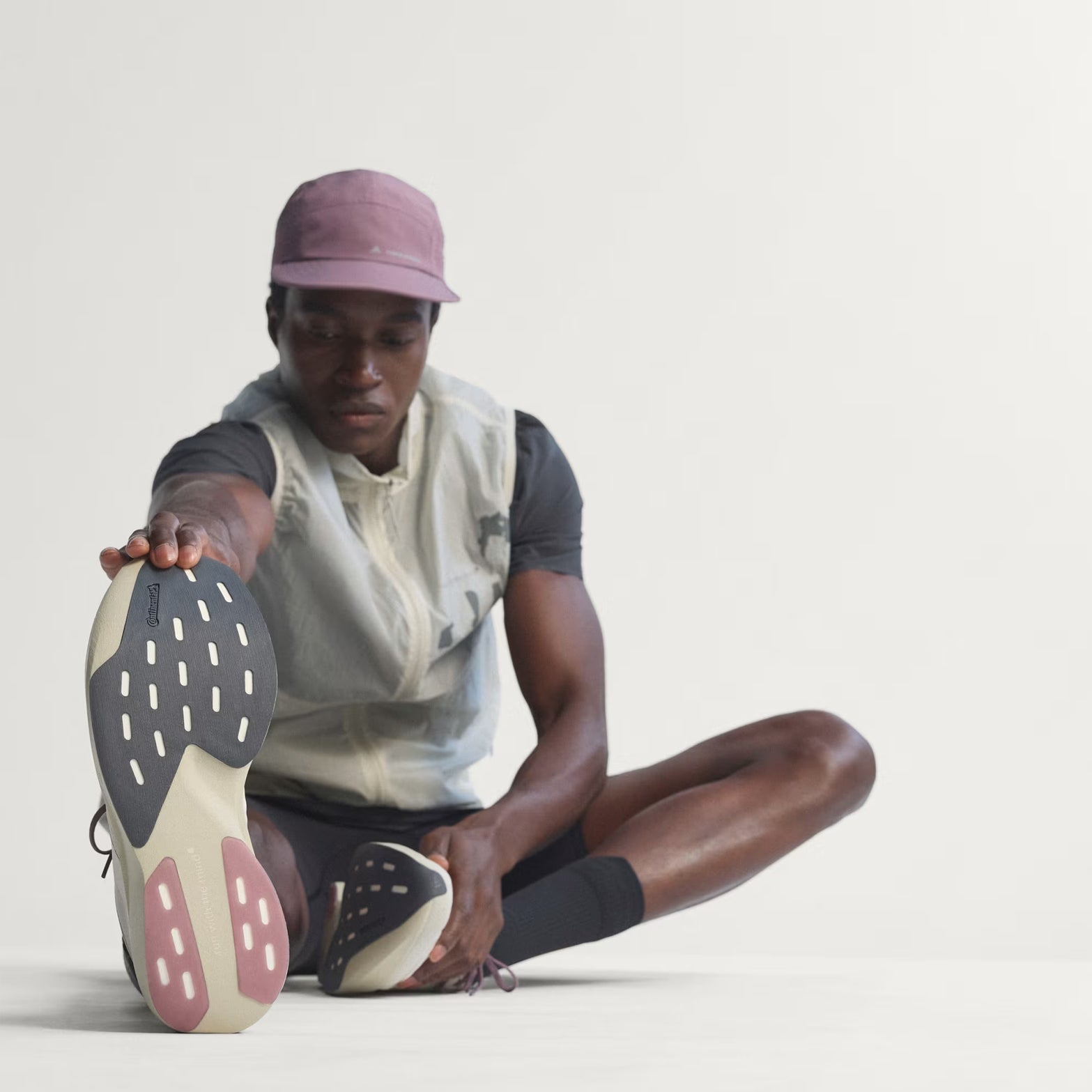 Men's Adizero EVO SL Woven H.Koumori Running Shoes Putty Grey Alumina Shadow Fig on stretching model displaying Continental Rubber outsole grip