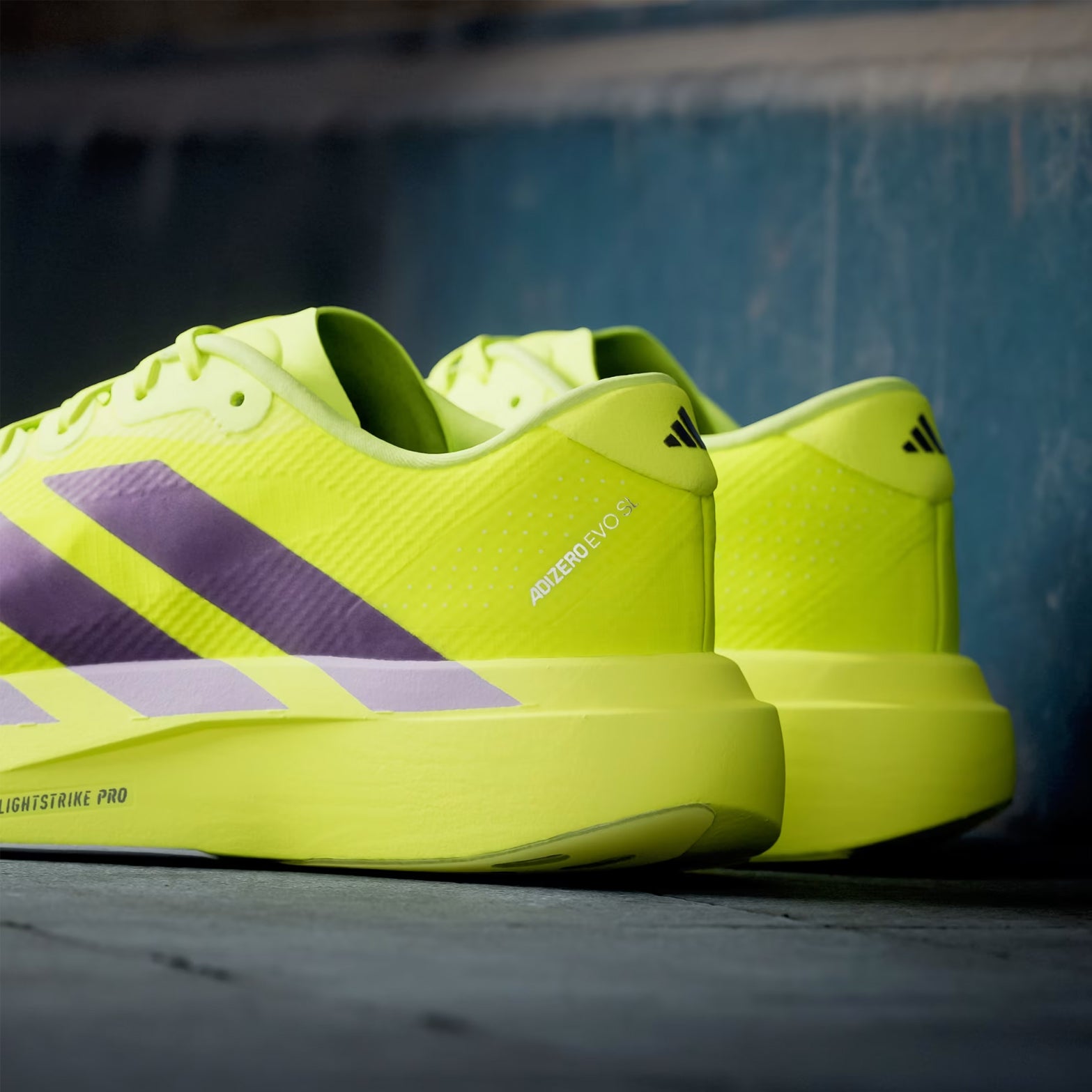 Men's adidas Adizero EVO SL Woven Running Shoes Solar Yellow Aurora Plum Powder Plum heel view showing LIGHTSTRIKE PRO foam stack with woven upper construction and racing-inspired design