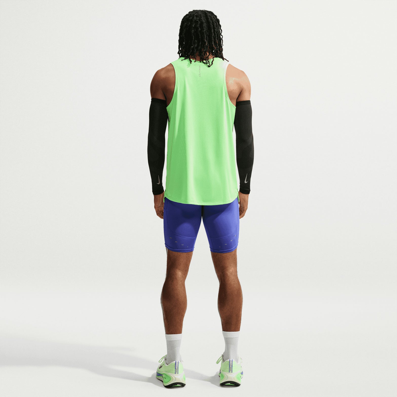 Men's Nike Aero-FIT Running Vest Volt Light Silver Reflective Silver back full body view on male runner showing Aero-FIT mesh zones with side hem vents for unrestricted movement and maximum airflow during running