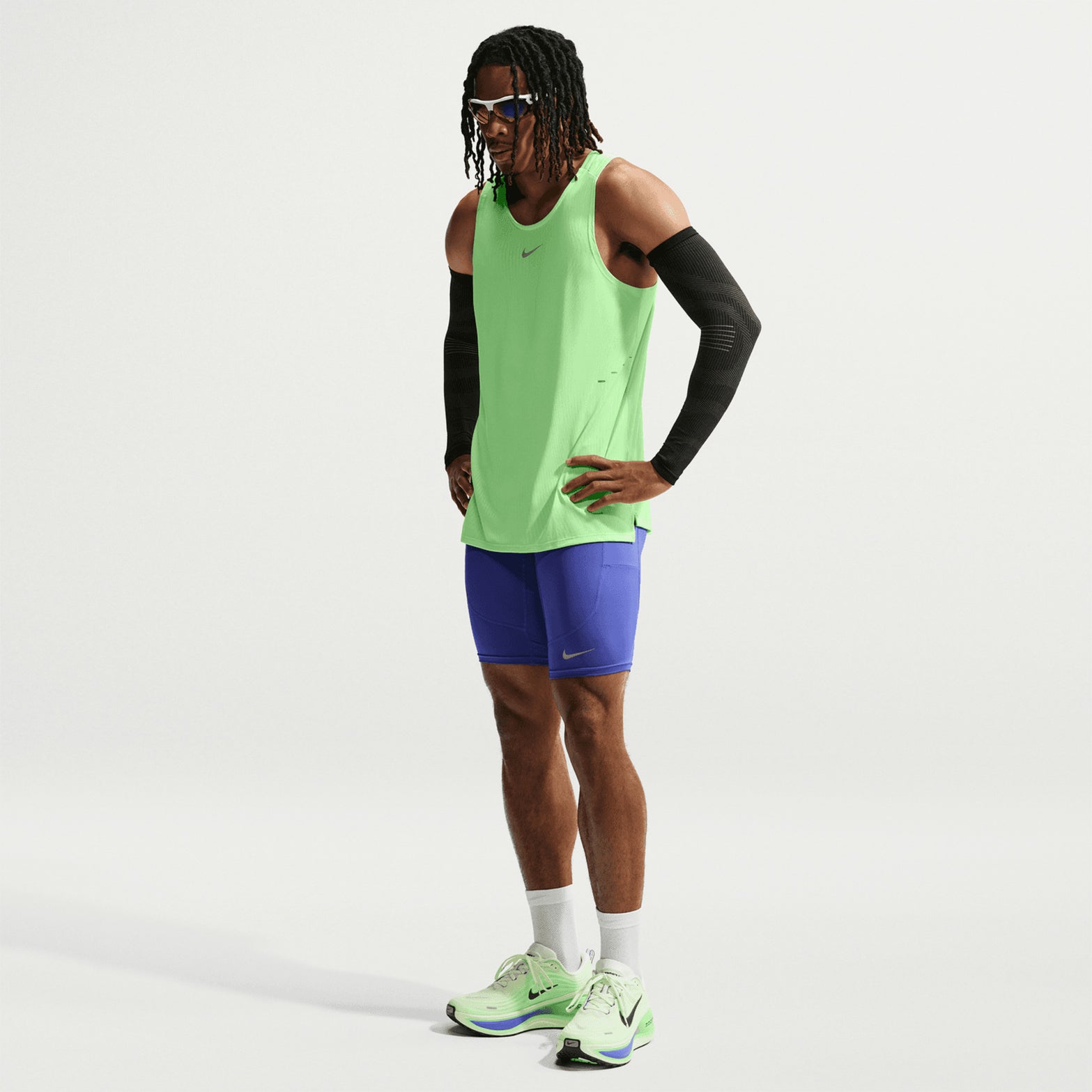 Men's Nike Aero-FIT Running Vest Volt Light Silver Reflective Silver front full body view on male runner showing lightweight knit with Aero-FIT mesh zones for maximum breathability and cooling during running