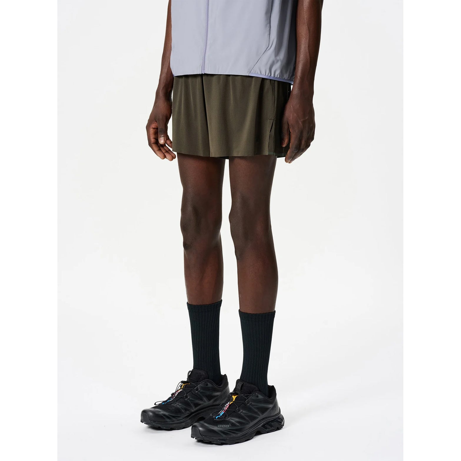 Goldwin Men's Air Pit Storage Shorts Jet Brown side view on male runner showing 13cm inseam with side slits for unrestricted leg movement and double elastic waistband