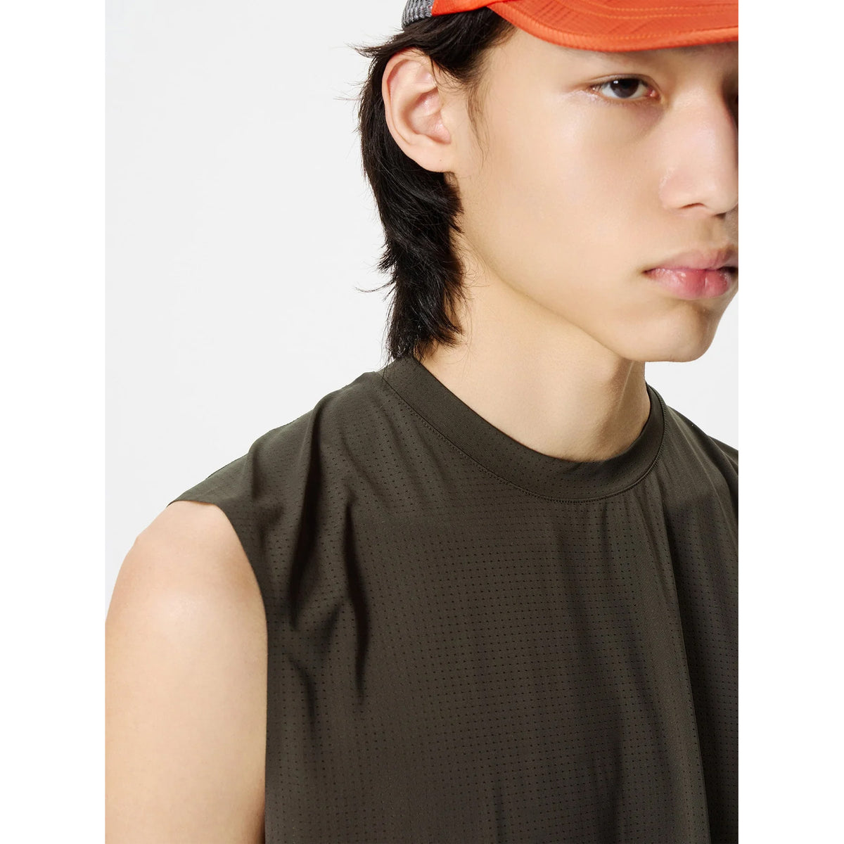 Goldwin Men's Air Pit Tank Jet Brown side close-up showing bonded seams at neckline and armholes with dot-structured mesh weave for air circulation