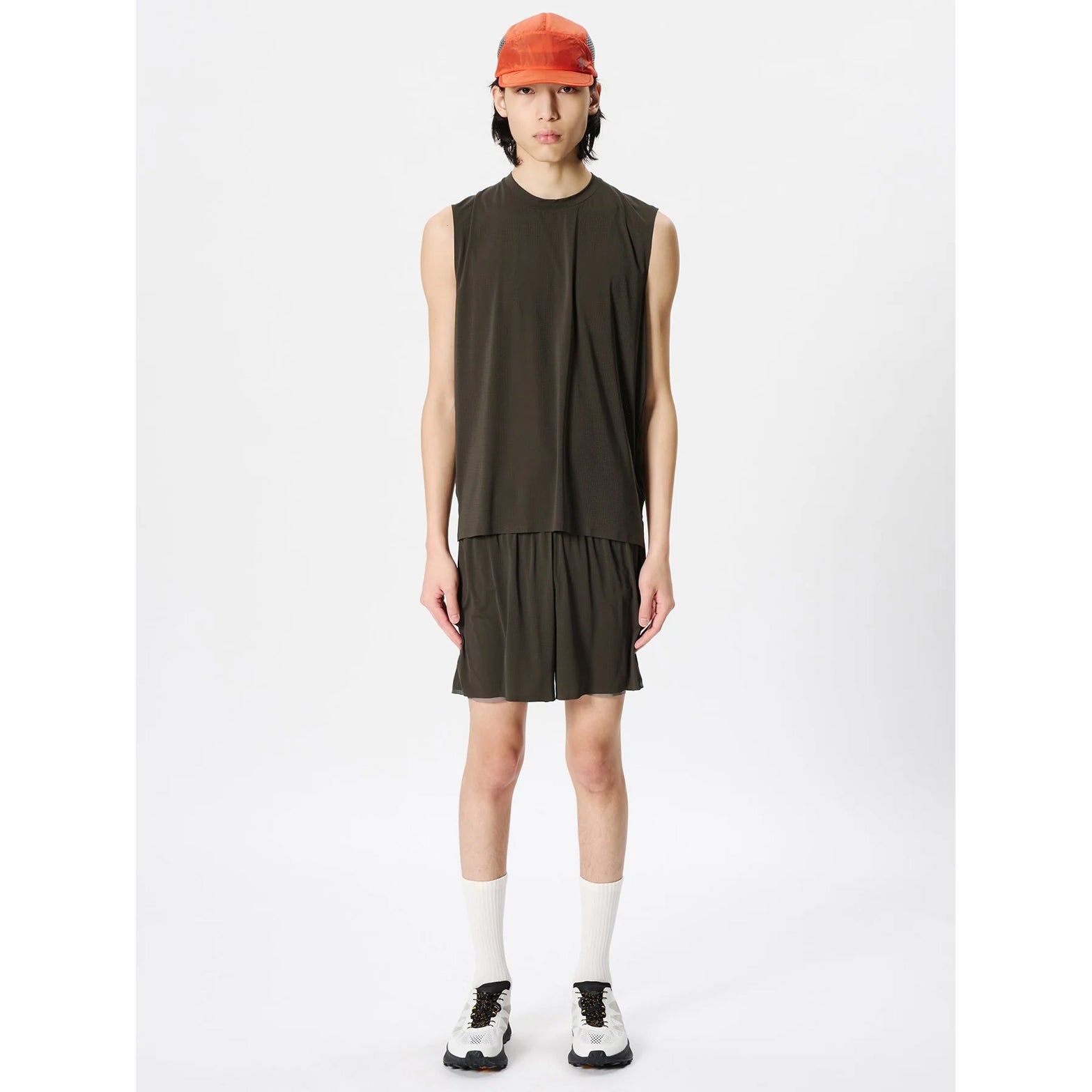 Goldwin Men's Air Pit Tank Jet Brown full body view on male model showing lightweight mesh vest with slightly loose cut for temperature regulation