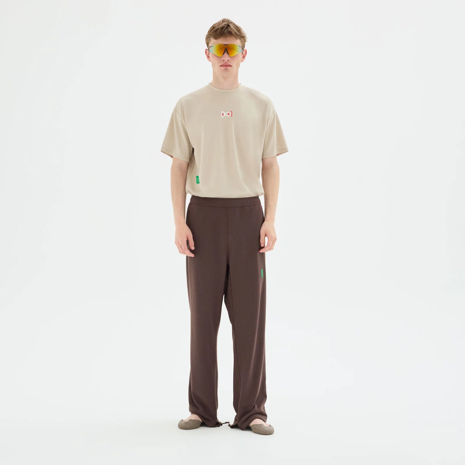 District Vision Short Sleeve Boxy Training Tee Beige full body view on male model showing relaxed boxy silhouette with lightweight breathable fabric for running and training