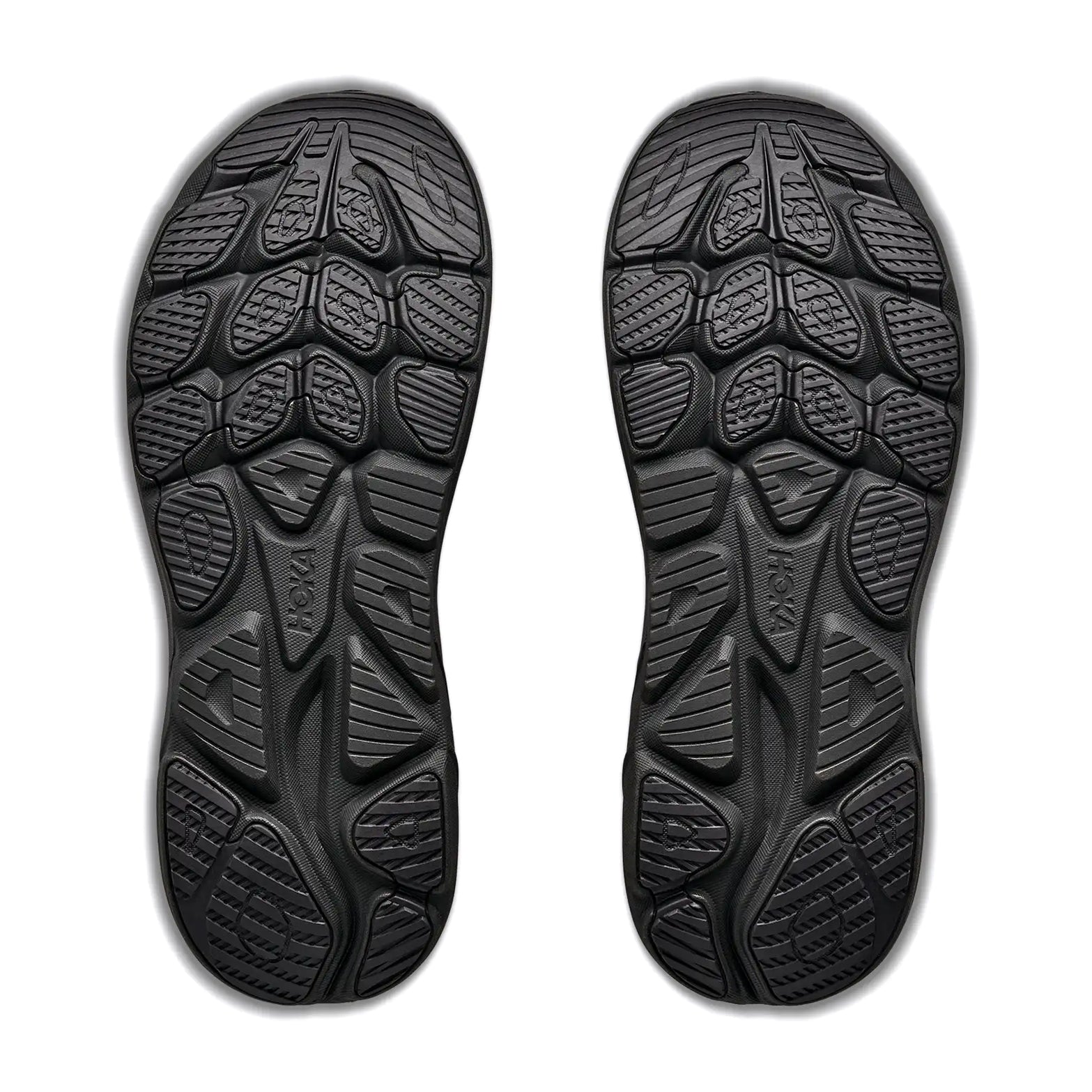 Pair of black shoe soles shown from below, featuring textured, patterned treads with geometric shapes for grip and traction. Inspired by the Hoka Men’s Clifton 11 GORE-TEX Running Shoes in Varsity Burgundy / Carbon Black, these soles are designed to provide both superior traction and ultra-smooth cushioning. White background.