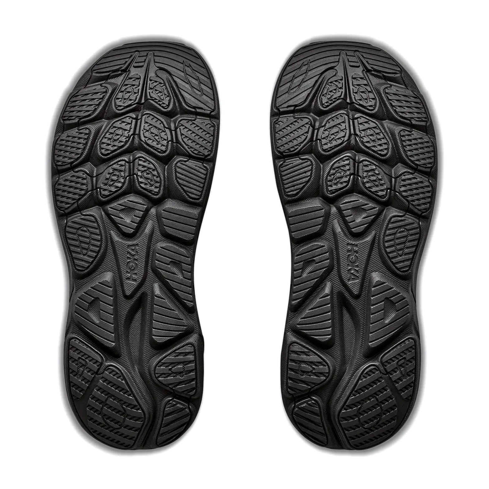 The Hoka Men’s Clifton 11 GORE-TEX Wide Fit Running Shoes in Black/Black feature textured rubber soles with irregular geometric tread patterns designed for enhanced grip and flexibility. Displayed side by side with the soles facing upward on a white background, these shoes are crafted specifically for runners who need a wide fit.