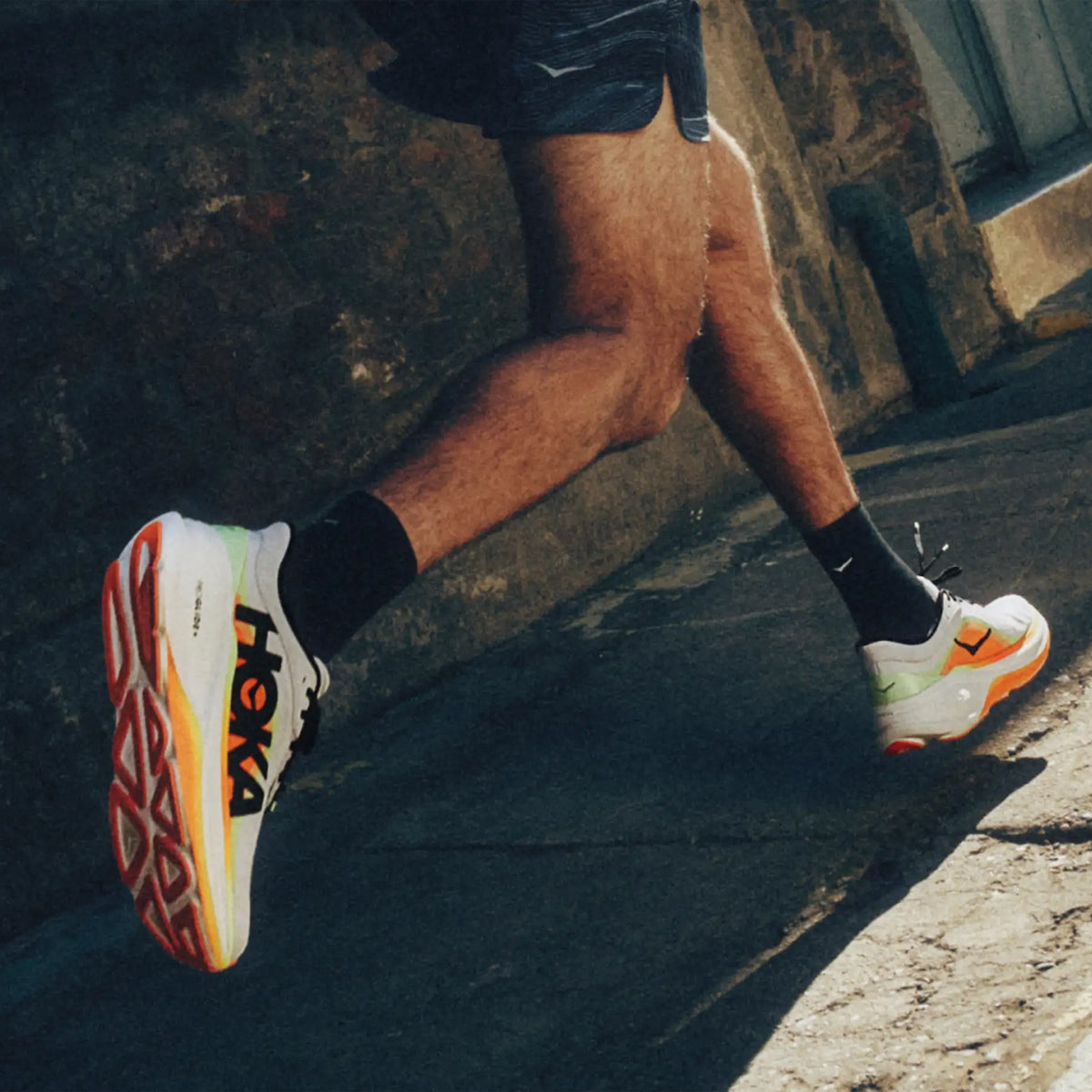 Men's HOKA Clifton Pro Running Shoes  on runner in motion showing PROGLIDE+ series SCF foam with aggressive MetaRocker geometry for lively smooth transitions during daily road running