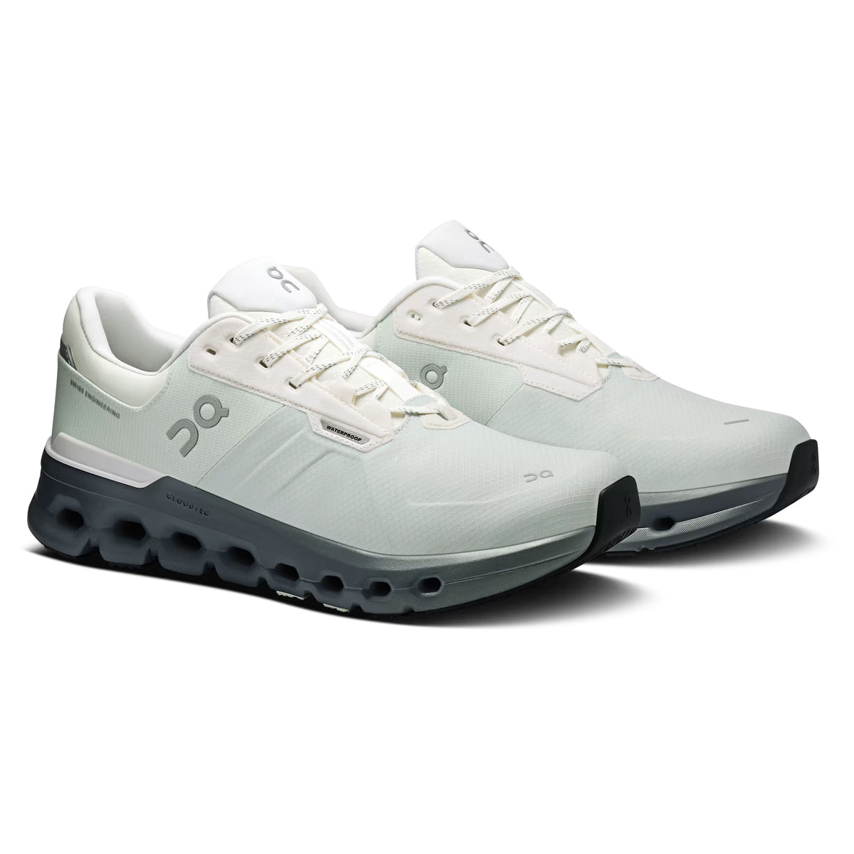 Pair of white and light gray athletic running shoes with black soles, featuring the On brand logo on the side and a modern, streamlined design.