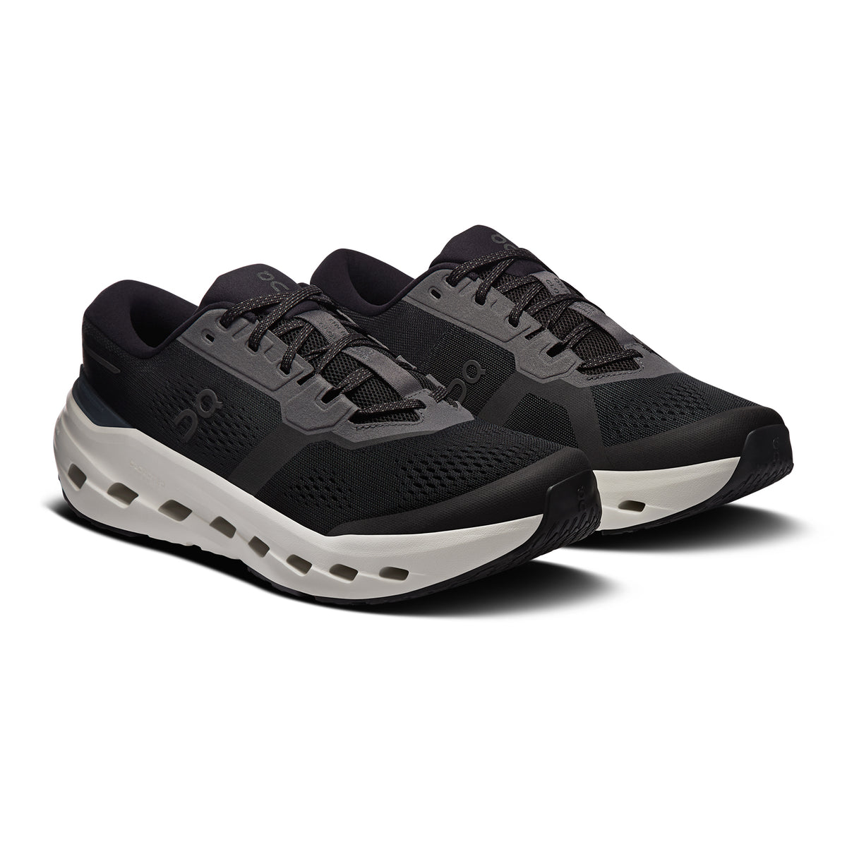 A pair of black and dark gray athletic running shoes with white soles, viewed at an angle on a white background.